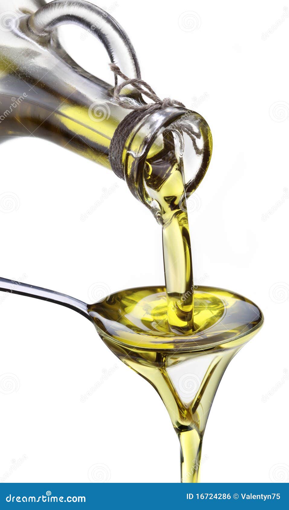 Olive Oil Flowing from Carafe into the Spoon. Stock Photo Image of