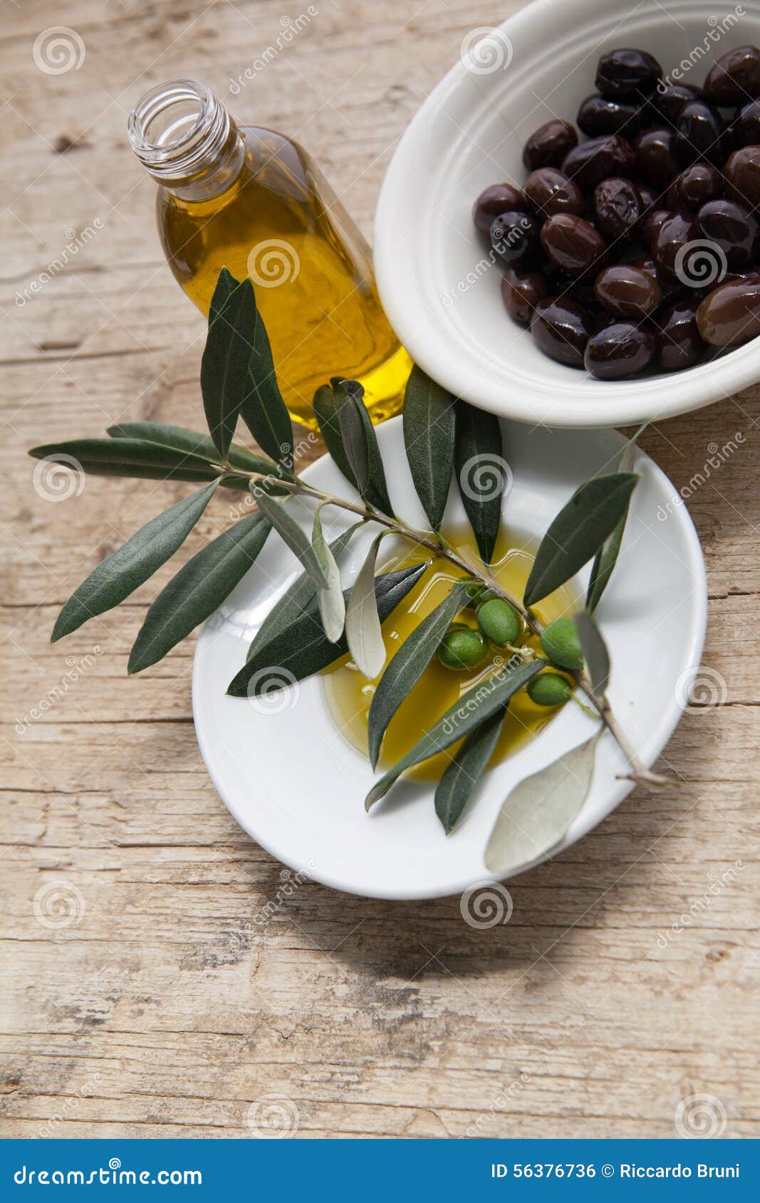 Olive oil on wooden table stock photo. Image of condiment 56376736