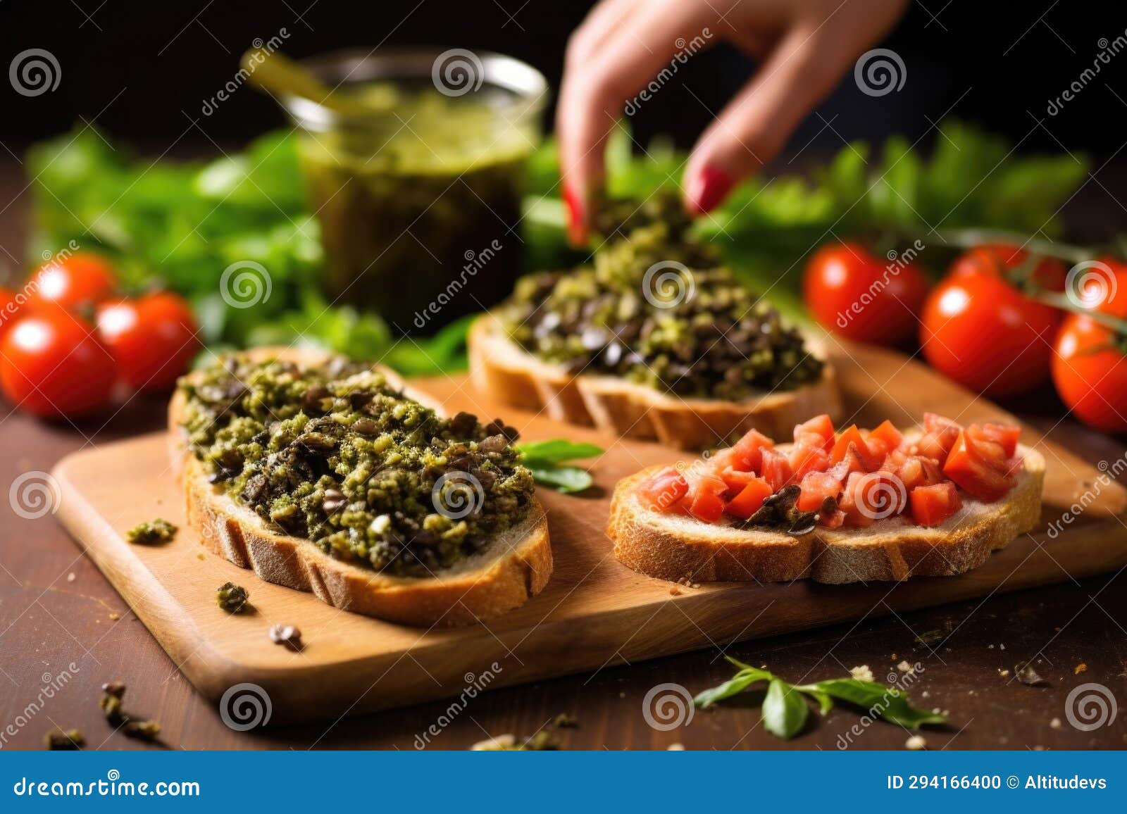 Olive Tapenade Being Spread on Bread for Bruschetta with Hand Stock