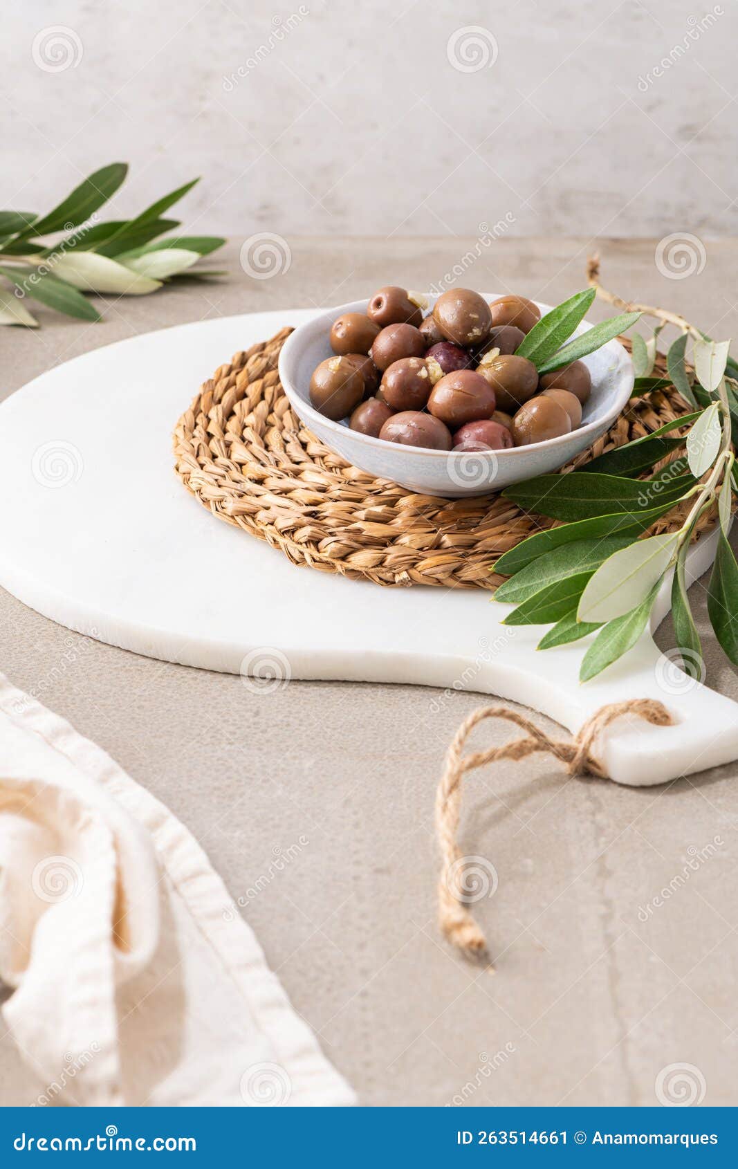 Olives with Olive Leaves in Ceramic Bowl on Kitchen Countertop Stock
