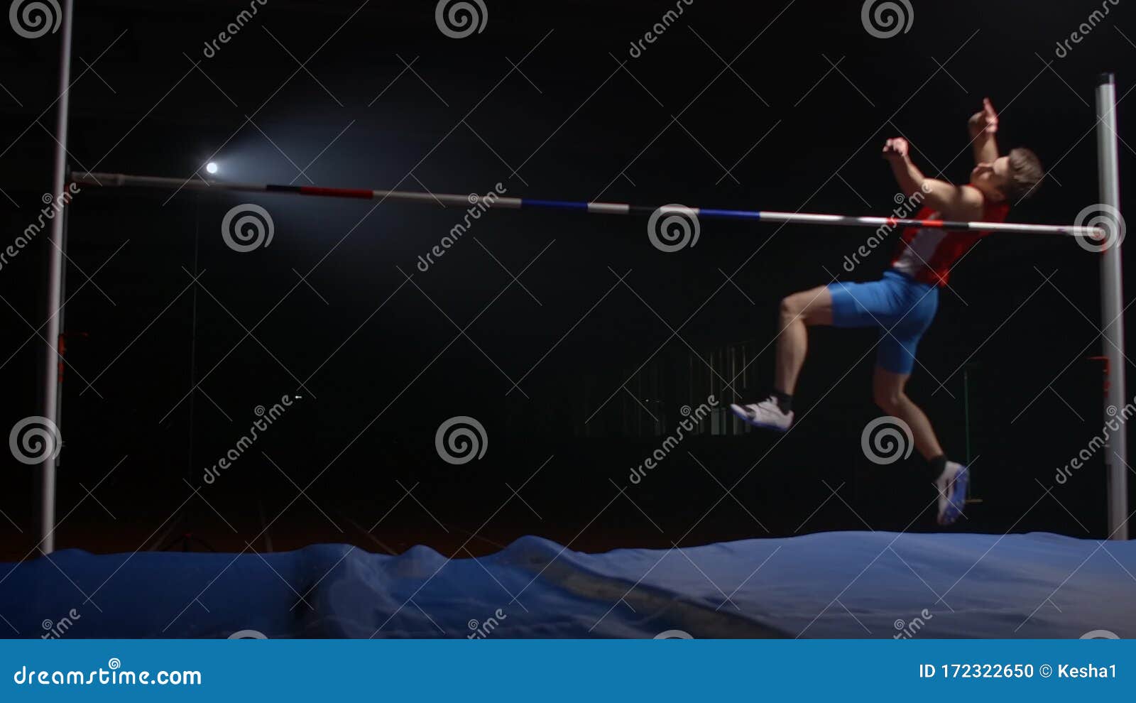 Olympic Sport a Man Performs a High Jump Over a Crossbar in Slow Motion