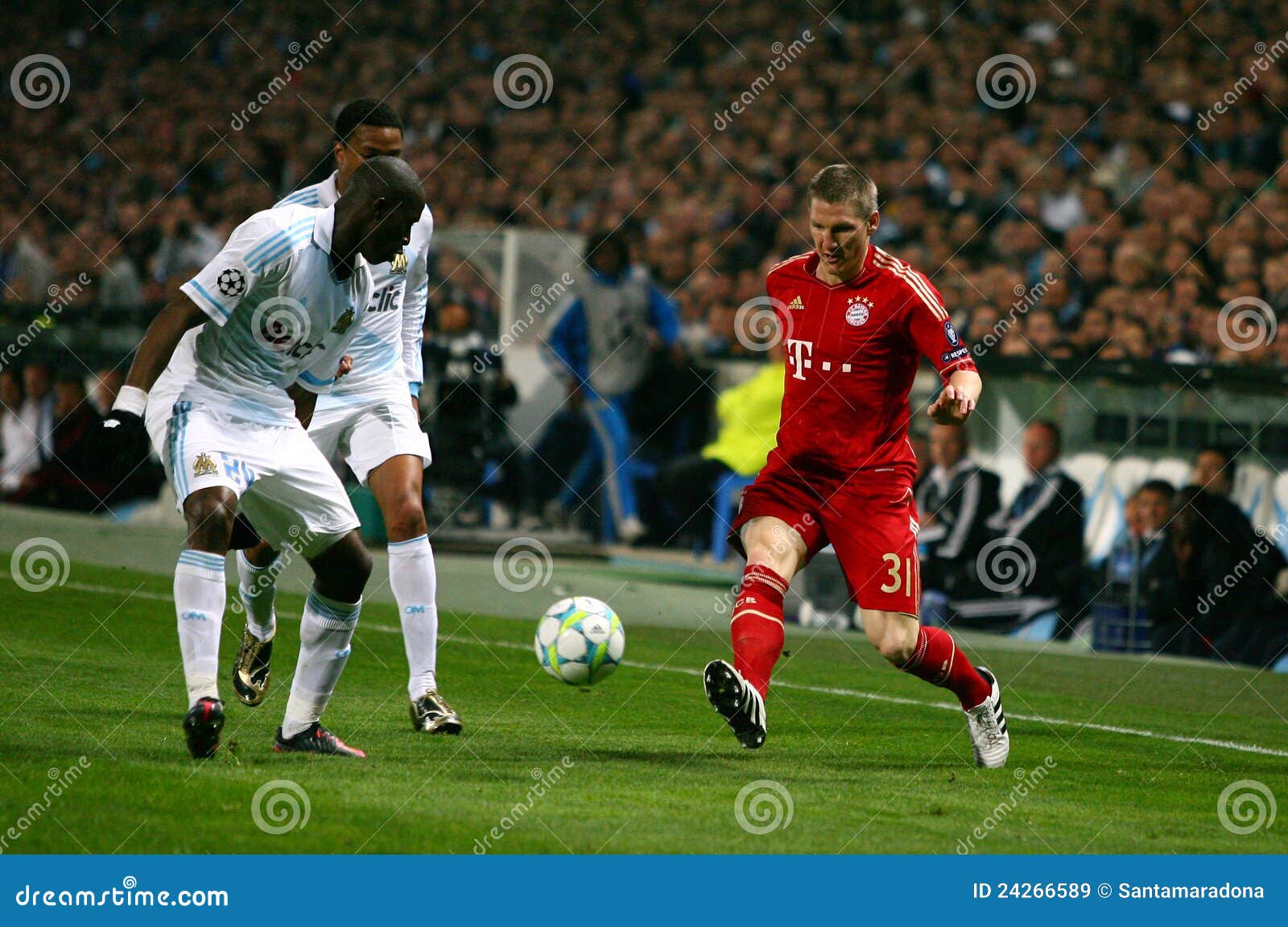 Olympique de Marseille vs Bayern Munchen. Bayern Munchen s Bastian Schweinsteiger during the Champions League soccer match OM vs Bayern Munchen. In the image also : the Olympique de Marseille s Rod Fanni and Loic Remy. At the Velodrome Stadium in Marseille, south of France on March 28, 2012.