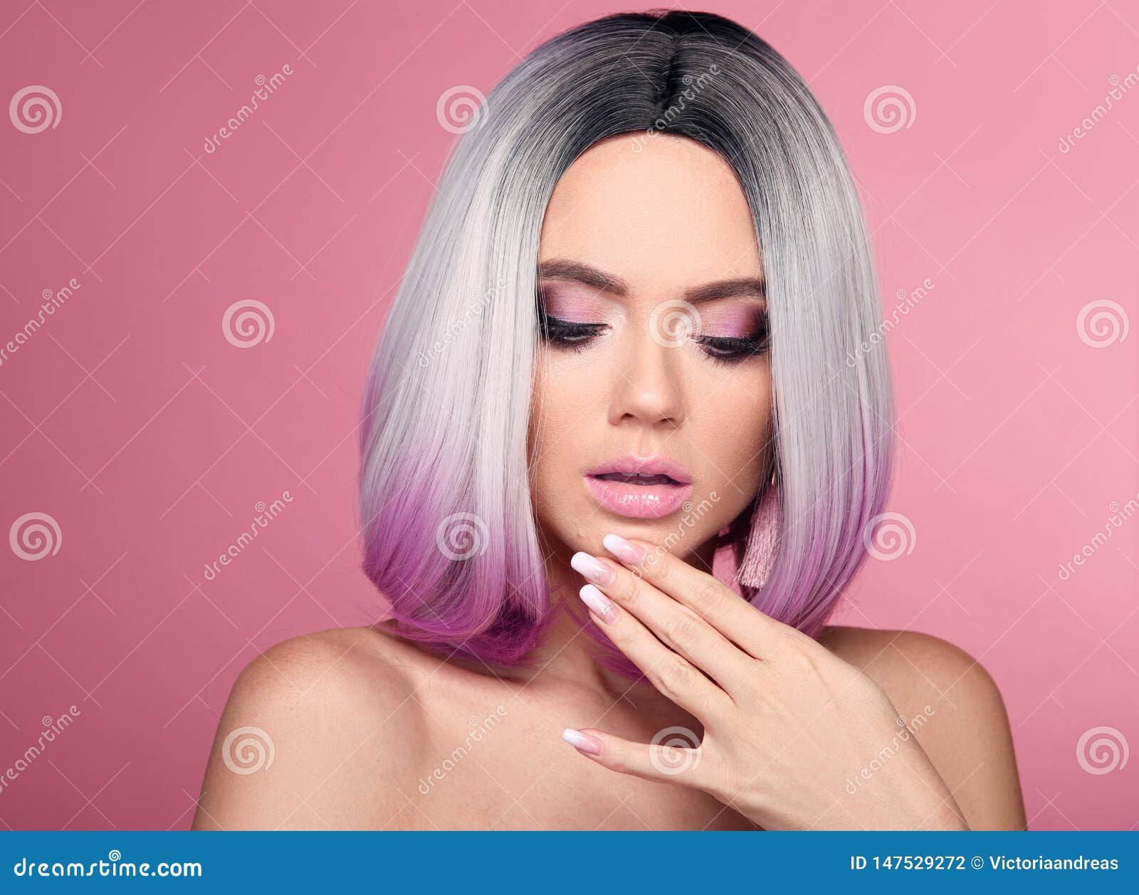 ombre bob short hairstyle and manicured nails. beauty makeup. beautiful hair coloring woman with wow face holding hand near her