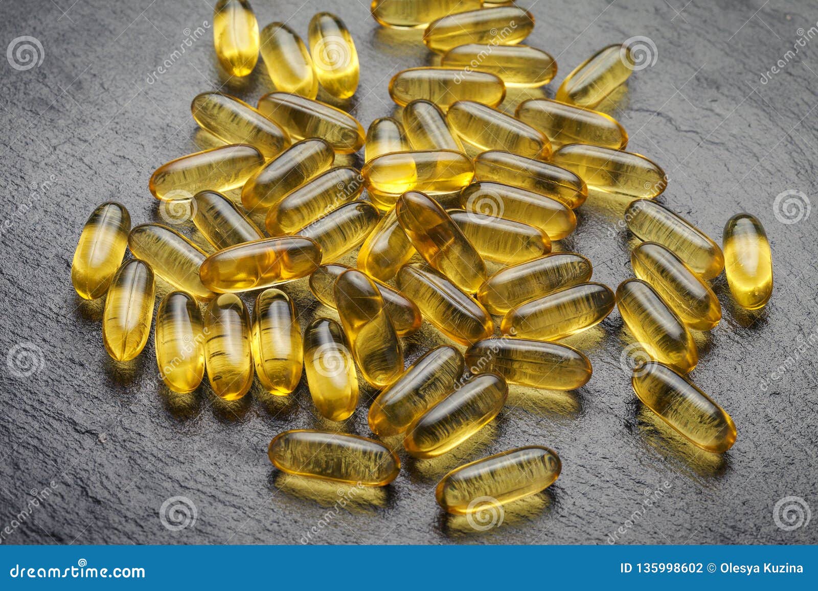 omega 3. transparent fish oil capsules on a black background