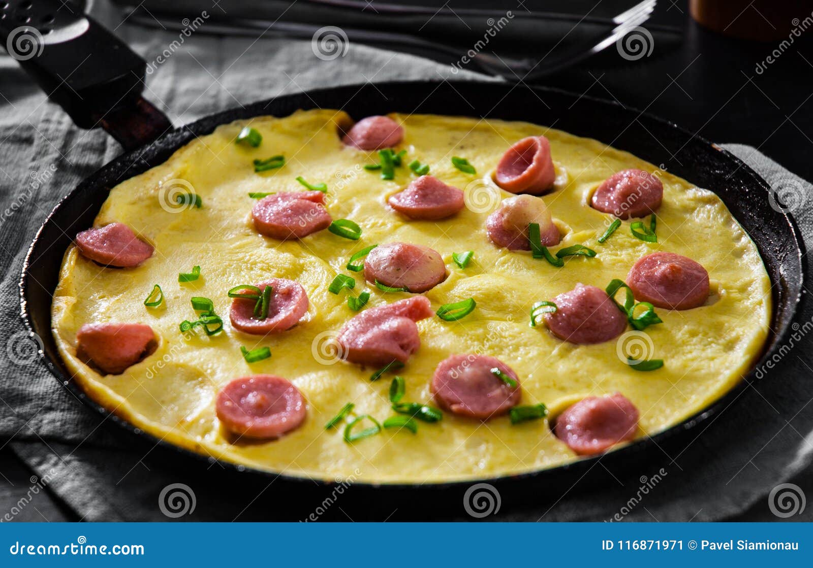 Omelette with Sausage in a Frying Pan on Wooden Table Stock Image