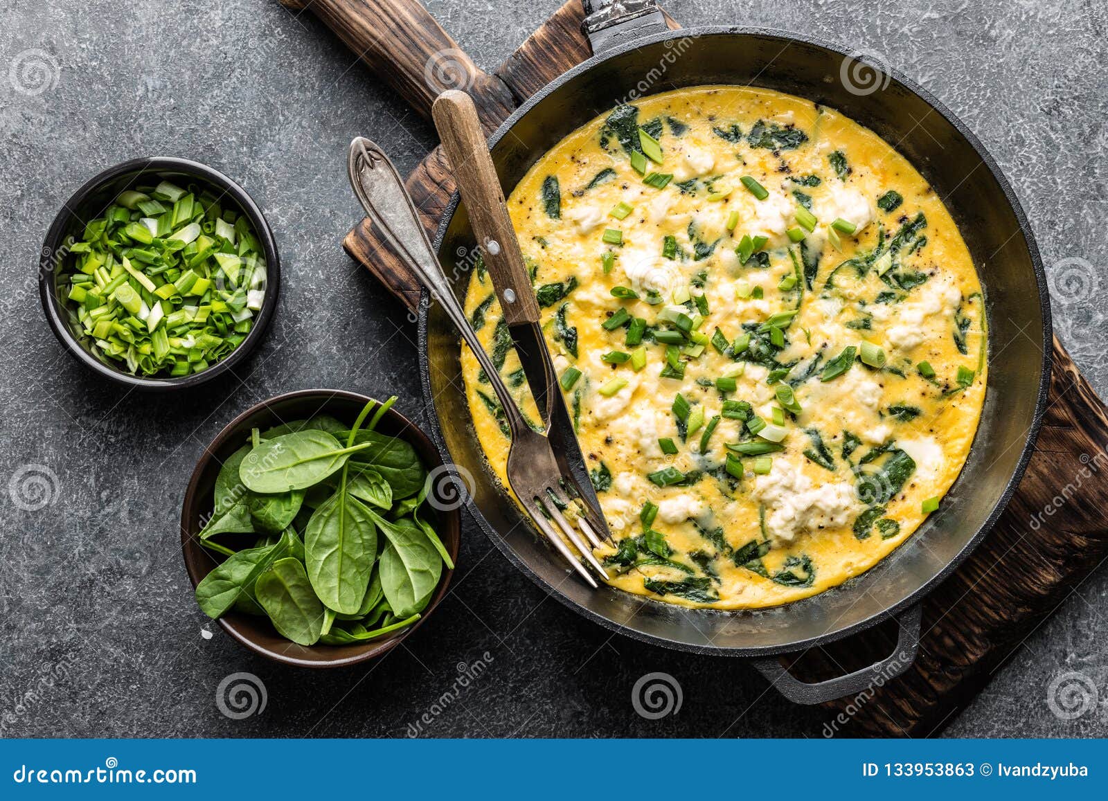 omelette with spinach and cheese in a pan top view