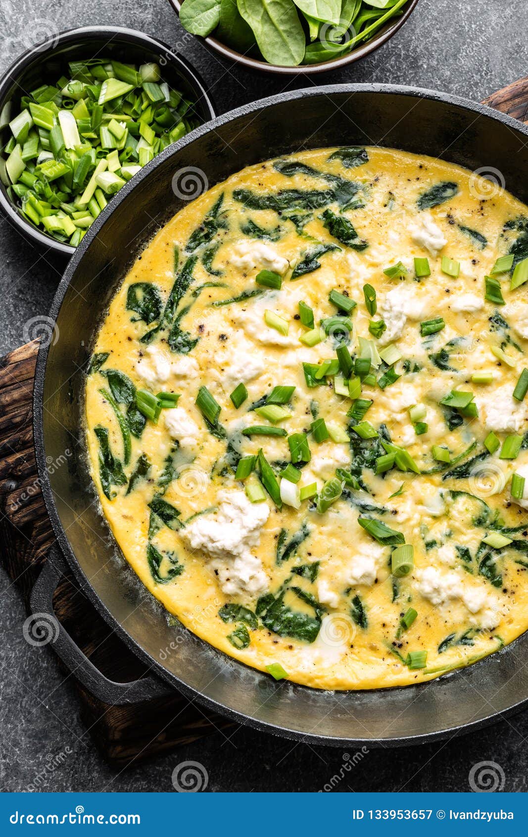 omelette with spinach and cheese in a pan top view