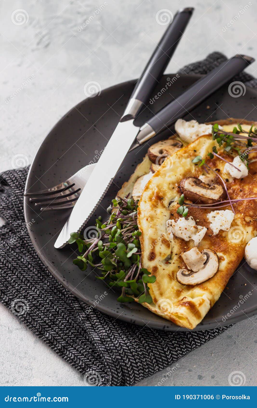 Omelette Stuffed with Mushroom, Mozzarella Cheese and Microgreens for Breakfast. Home Kitchen