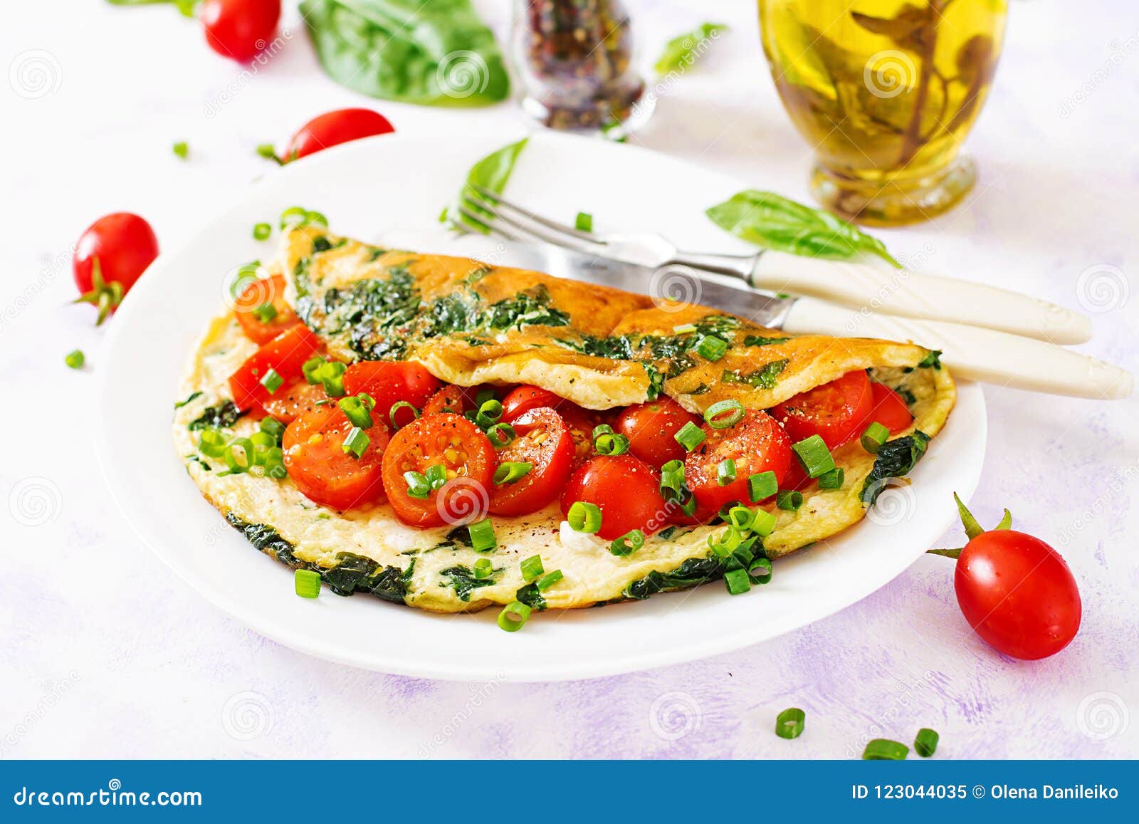 Omelette with Tomatoes, Spinach and Green Onion on White Plate. Stock ...