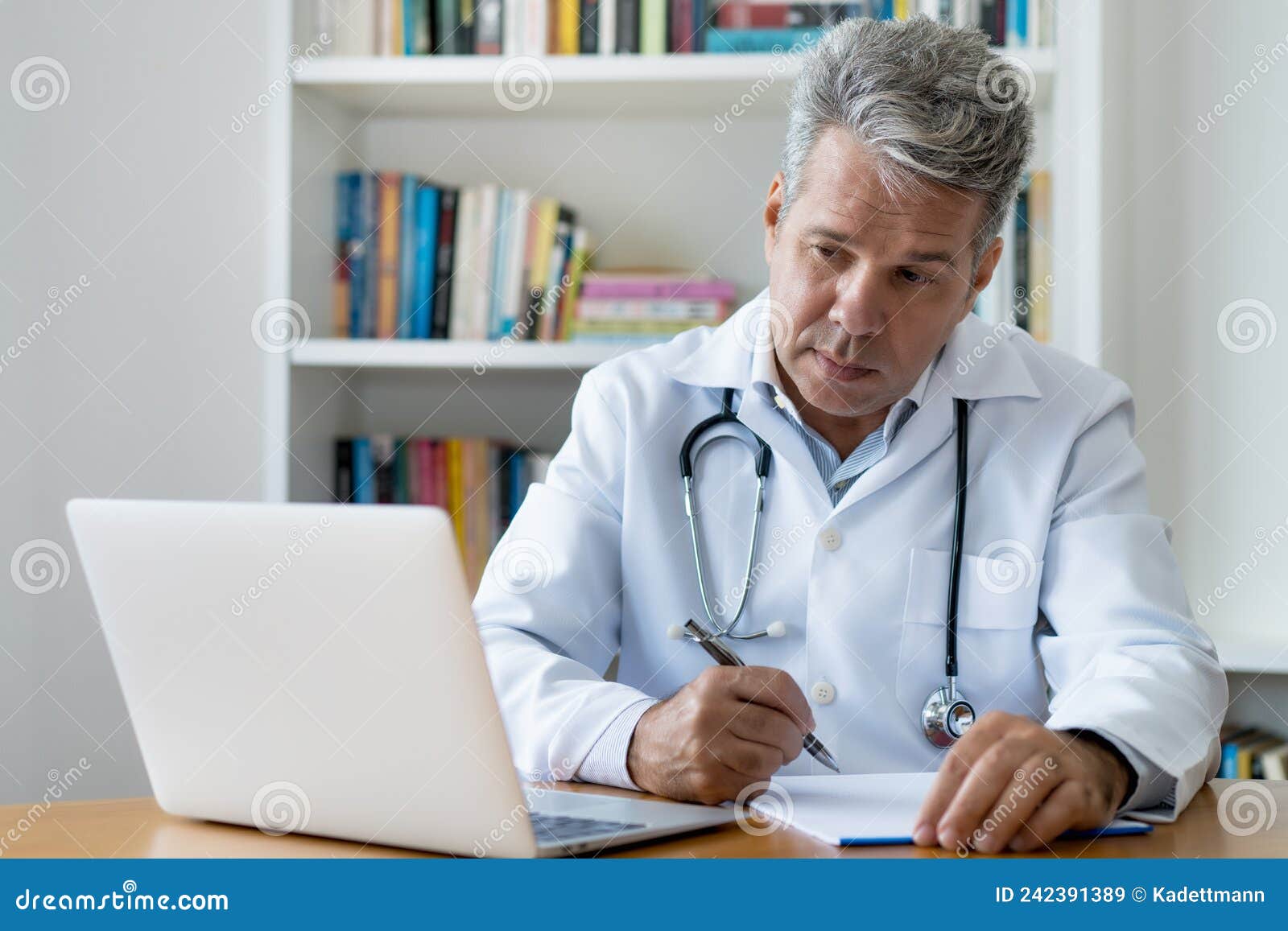 Oncologist Reading Studes about Cancer and Working at Computer Stock ...