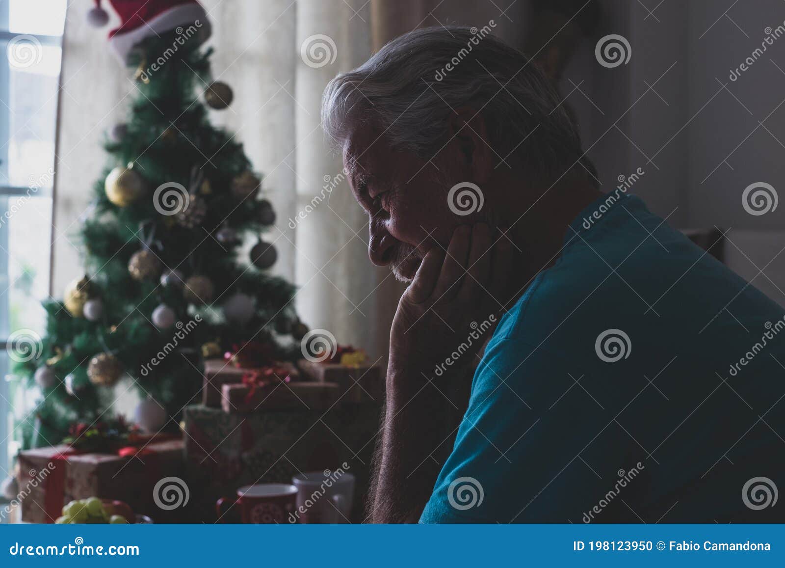 one alone and sad senior mature man sitting on the sofa at home celebrating christmas day alone with anyone people - upset adult
