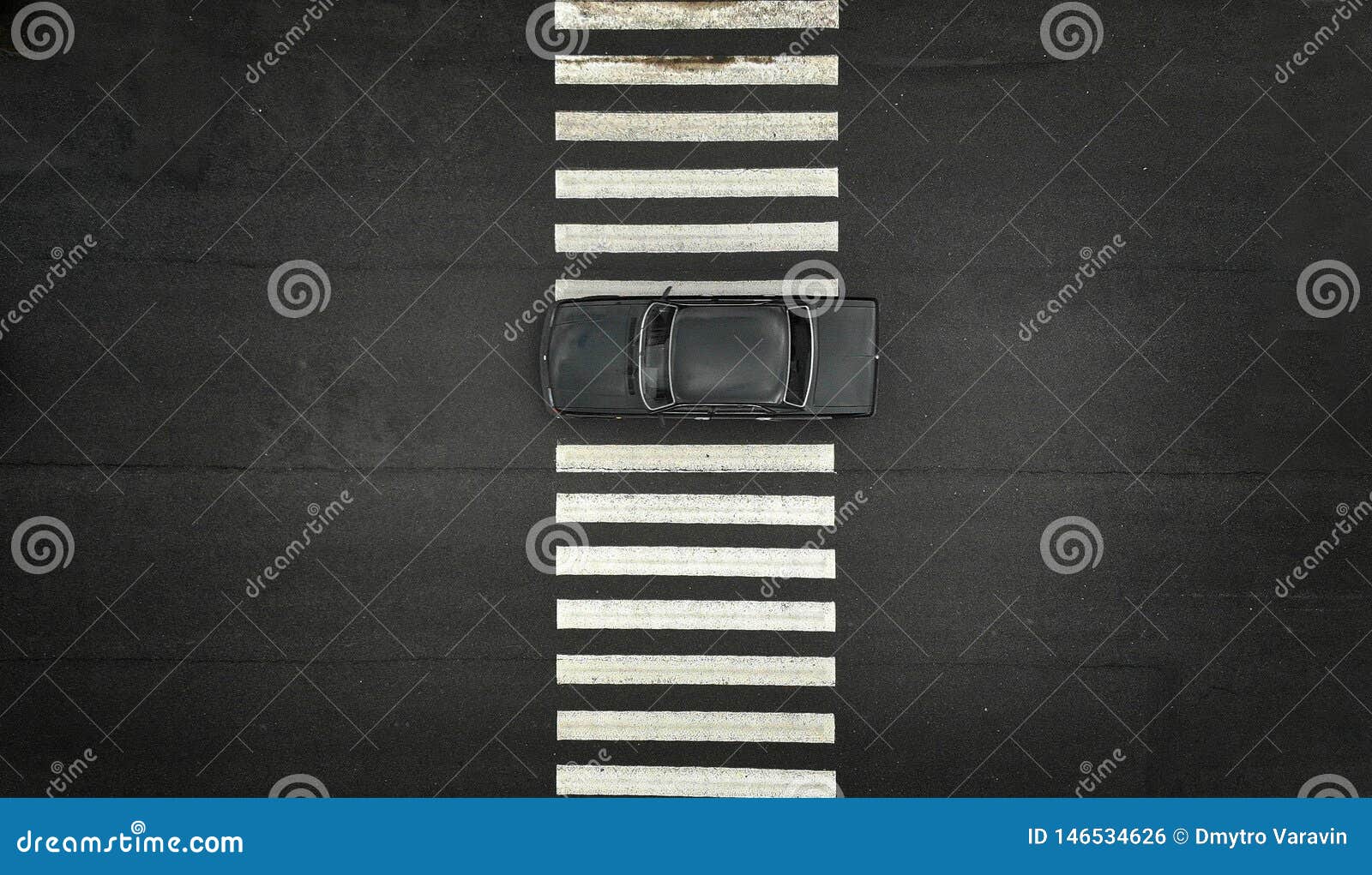 one black car on a zebra pedestrian crosswalk. black asphalt on a backdrop