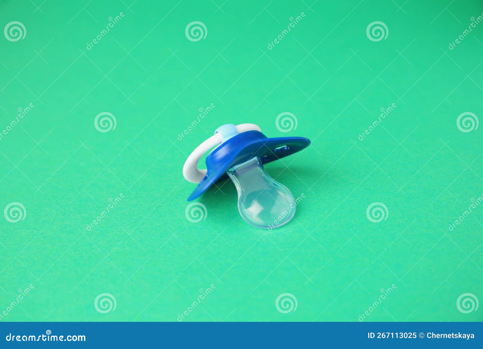 One Blue Baby Pacifier on Green Background Stock Image Image of
