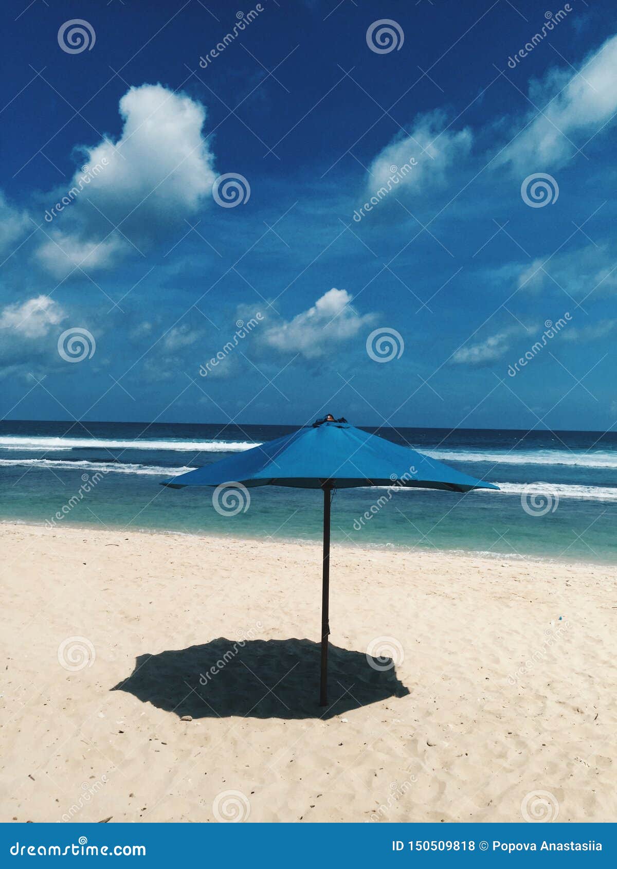 One Blue Beach Sun Umbrella Make Shade on the Sand Stock Photo Image