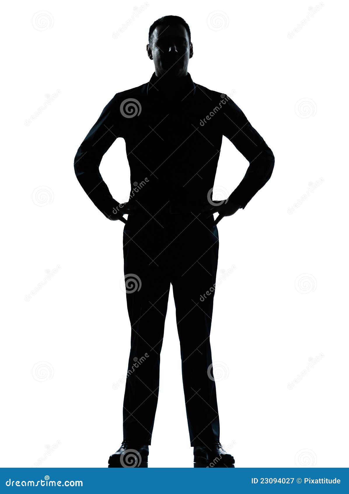 one business man standing hands on hips silhouette