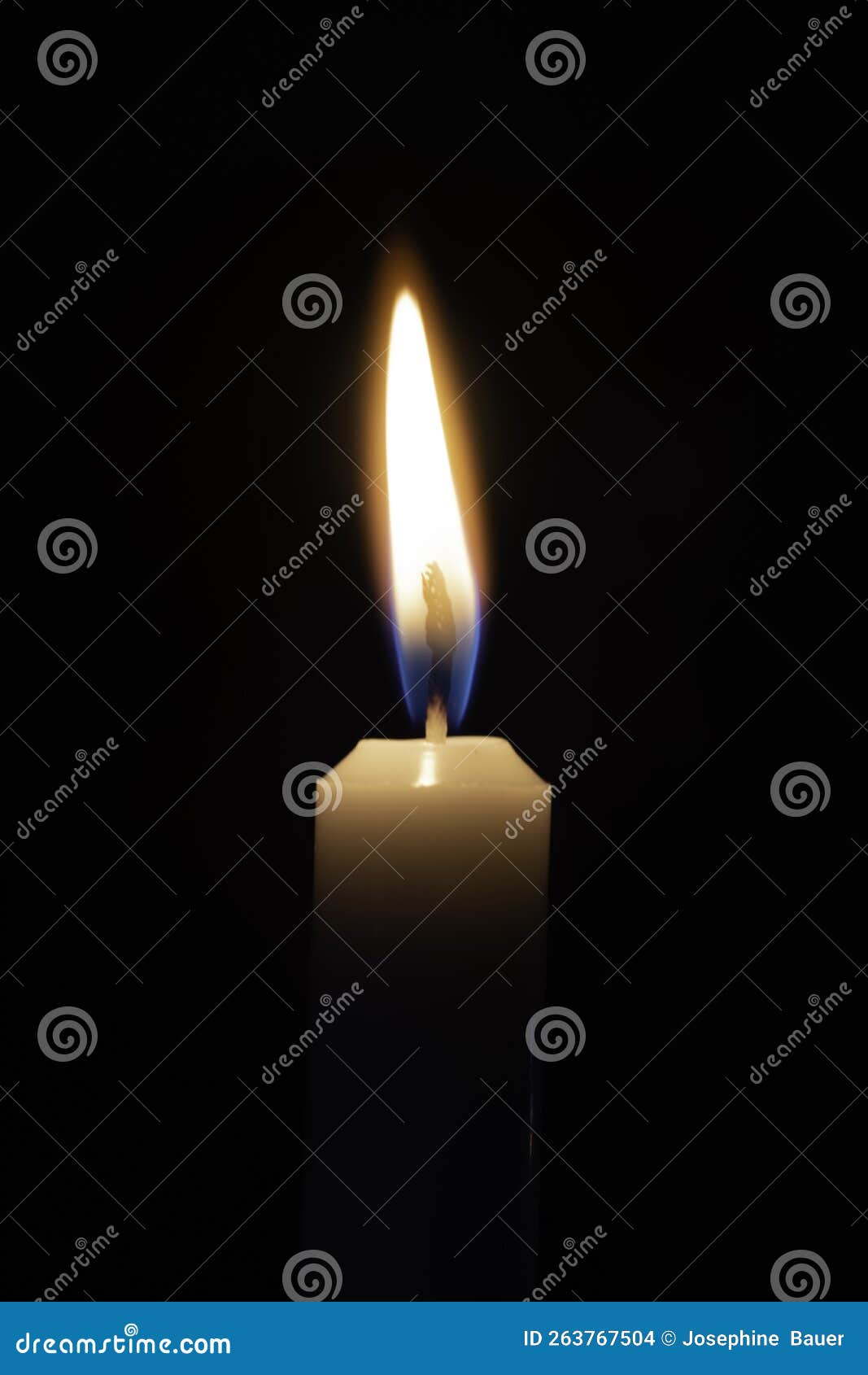 One Candle Burning Bright on a Solid Black Background Stock Photo