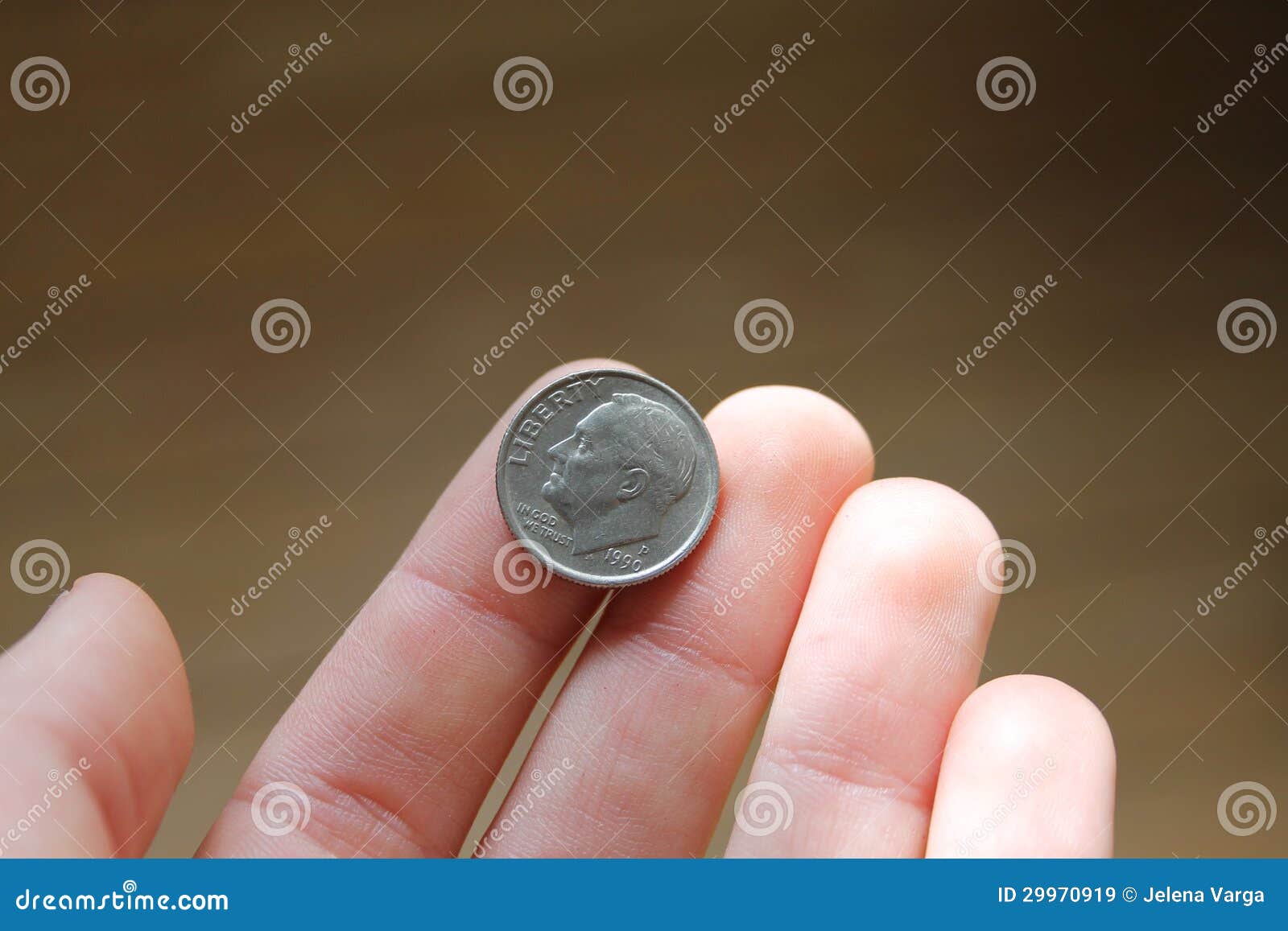 one dime in hand