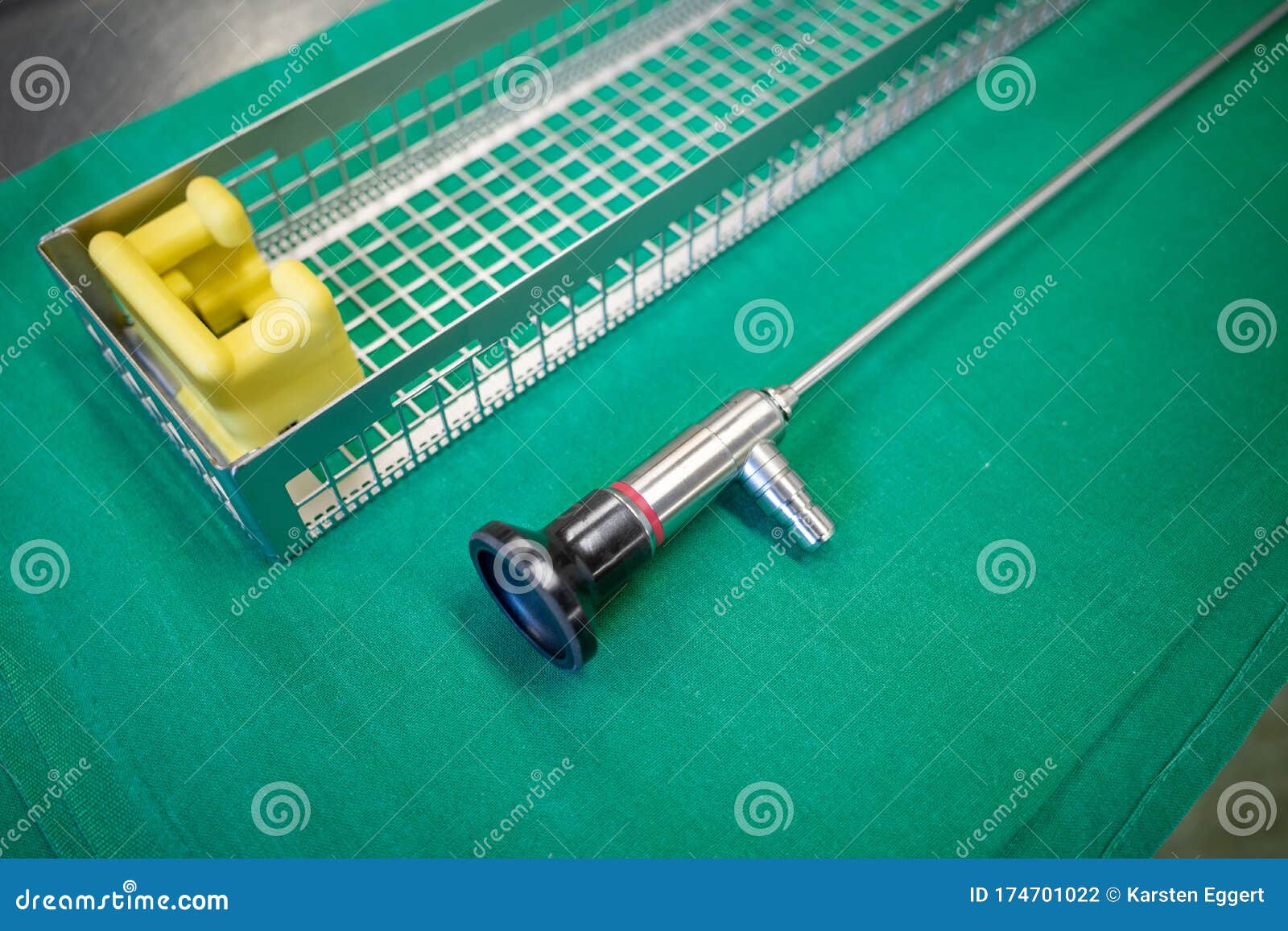 One Endoscopic Camera Lies on a Green Surgical Drape Next To a Tray