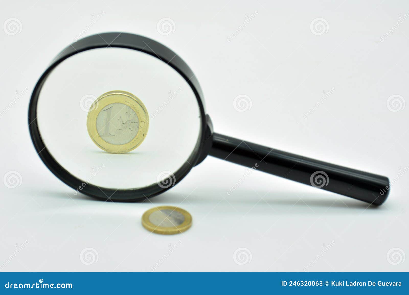 one euro coin observed with a magnifying glass