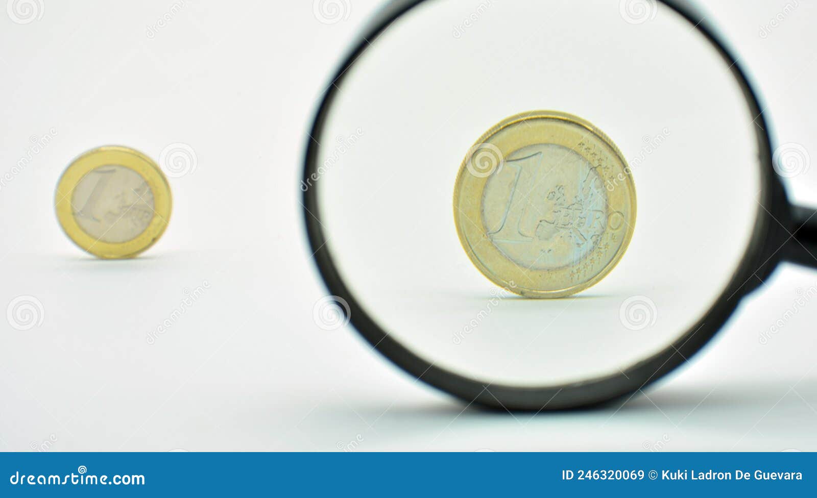 one euro coin observed with a magnifying glass