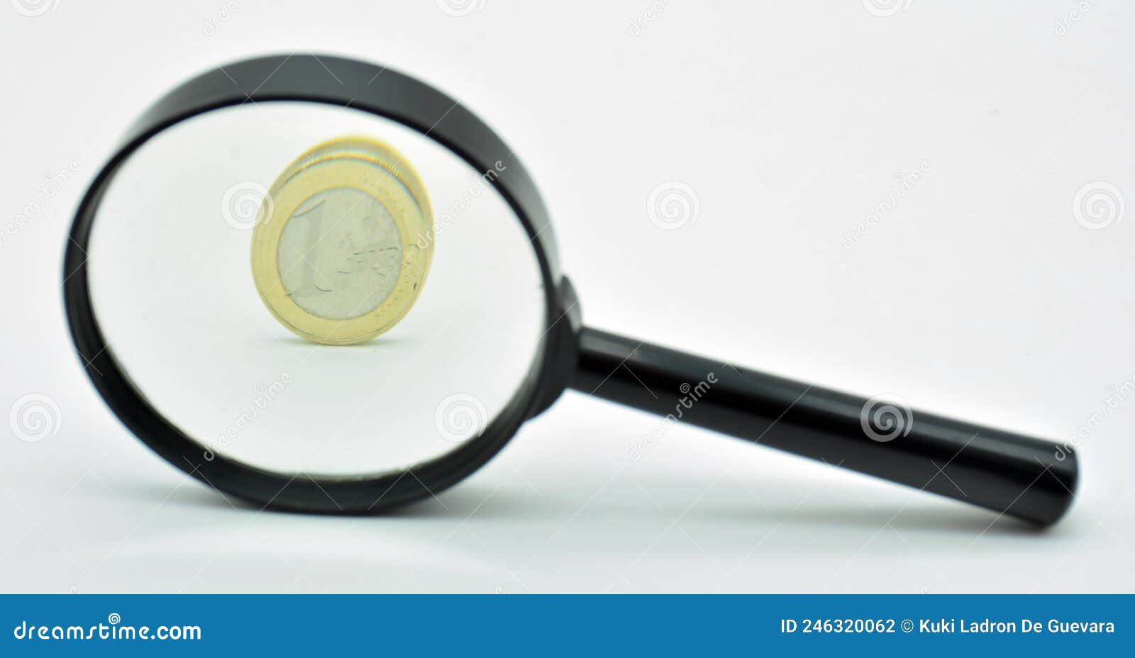 one euro coin observed with a magnifying glass