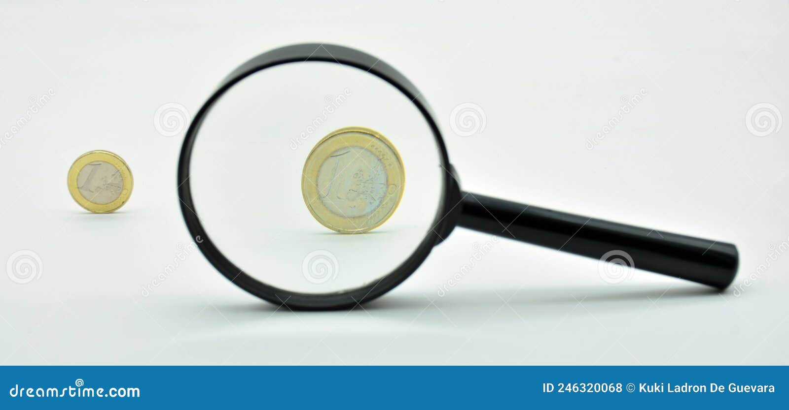 one euro coin observed with a magnifying glass