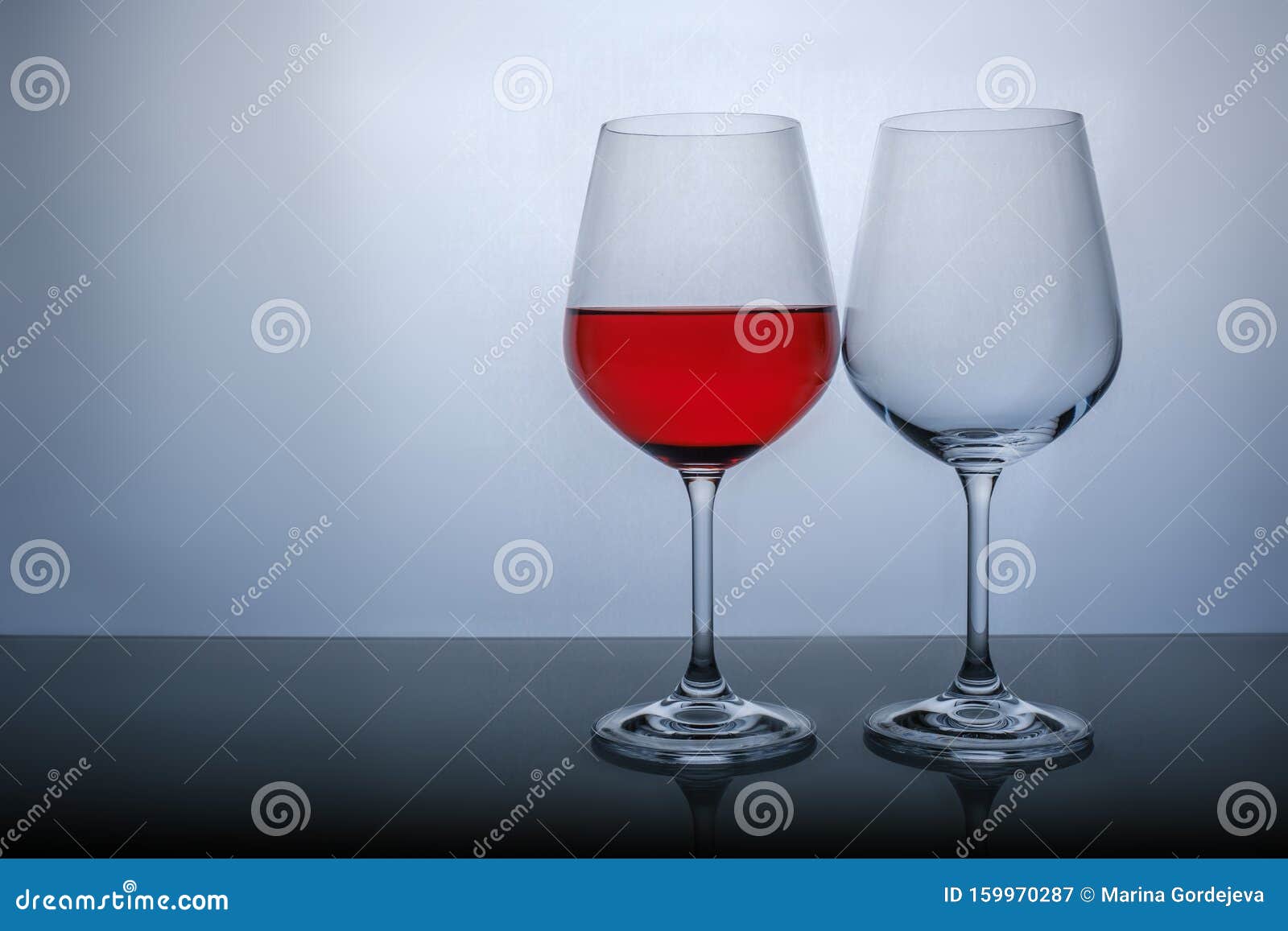 One Glass Half Full of Red Wine, and the Second Empty on a White Background Stock Image Image
