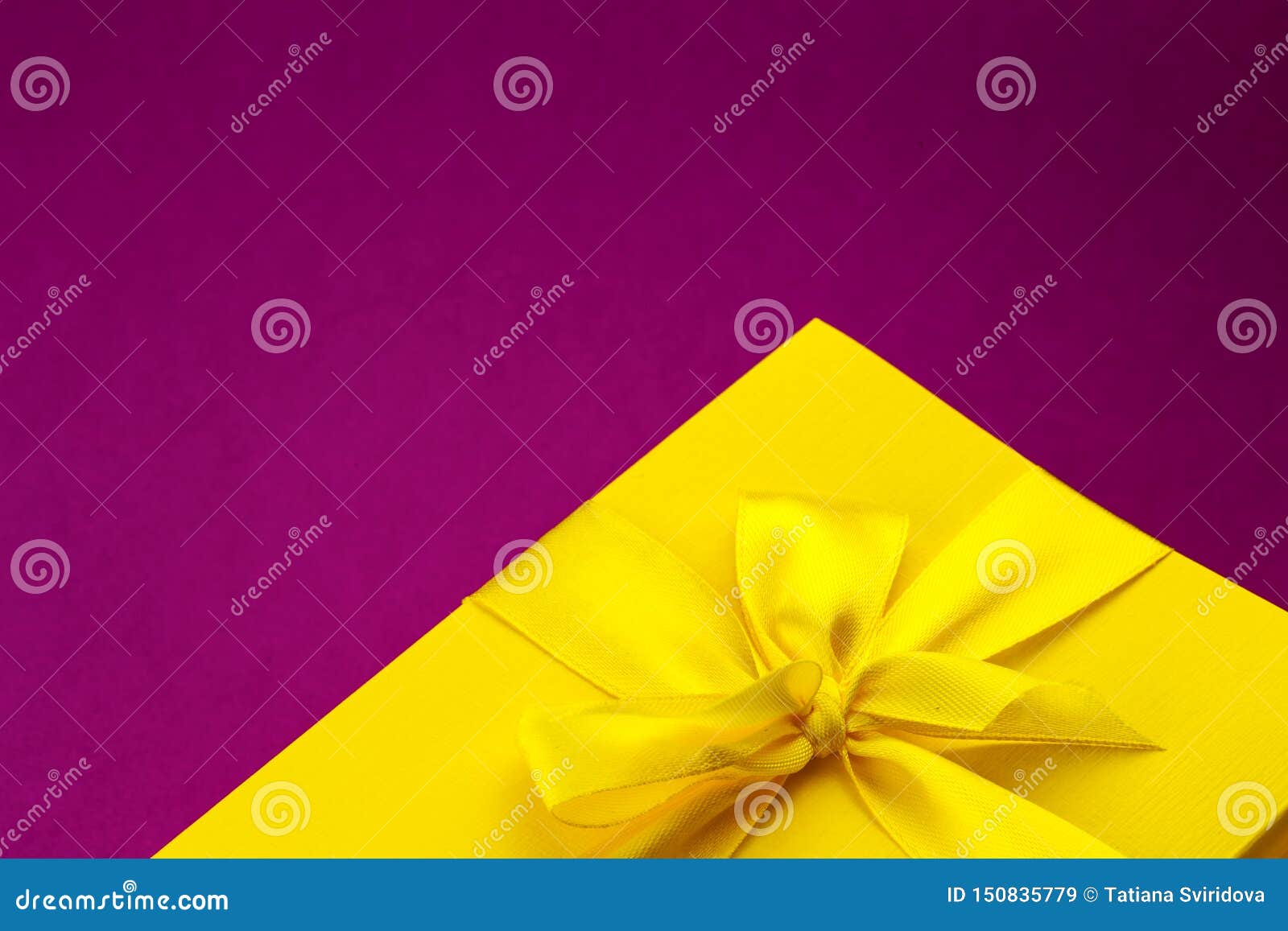 Bright Yellow Giftbox On Dark Pink Background Stock Image