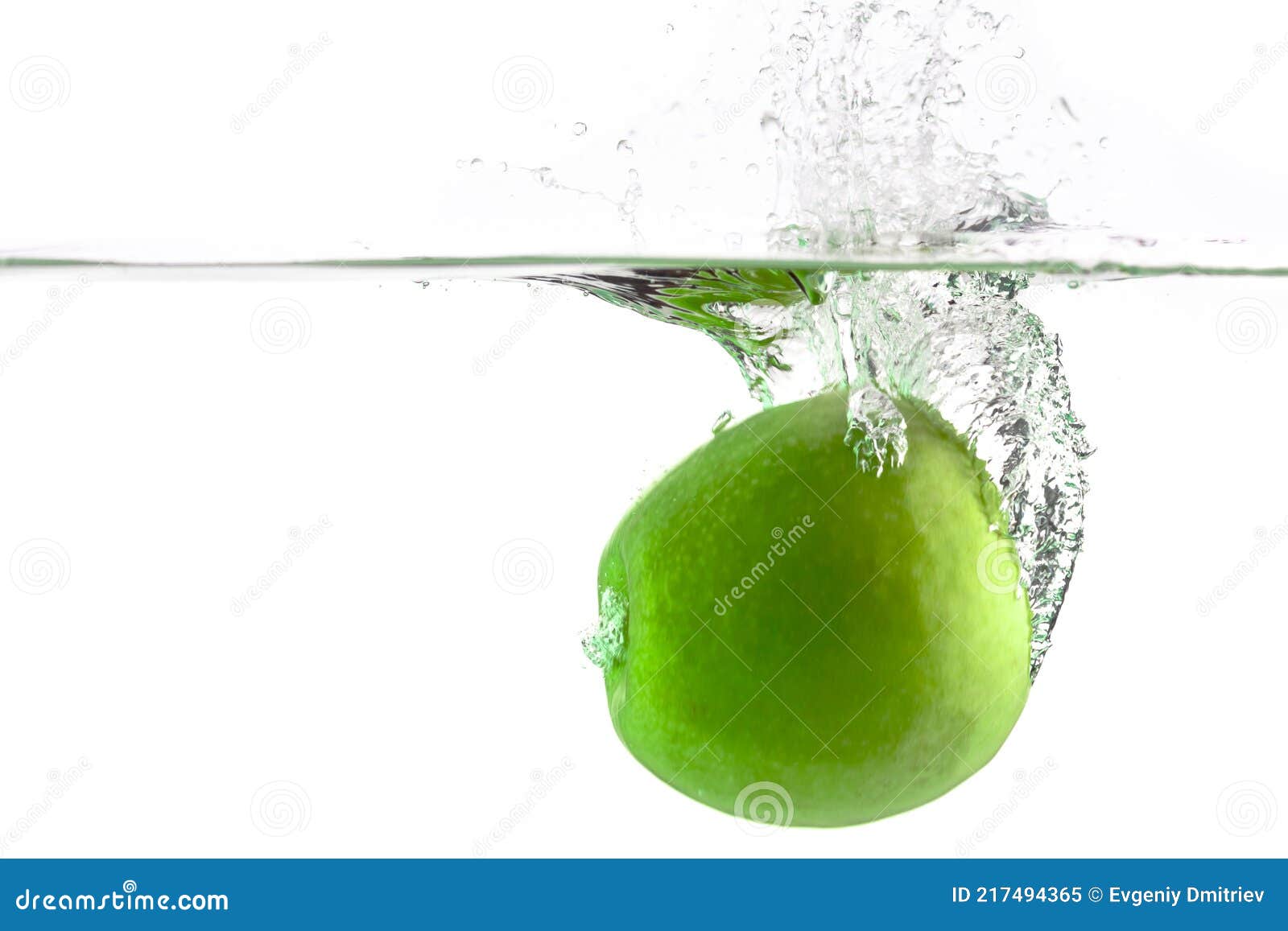 One Green Apple Falling into Water on a White Background with Splashes ...