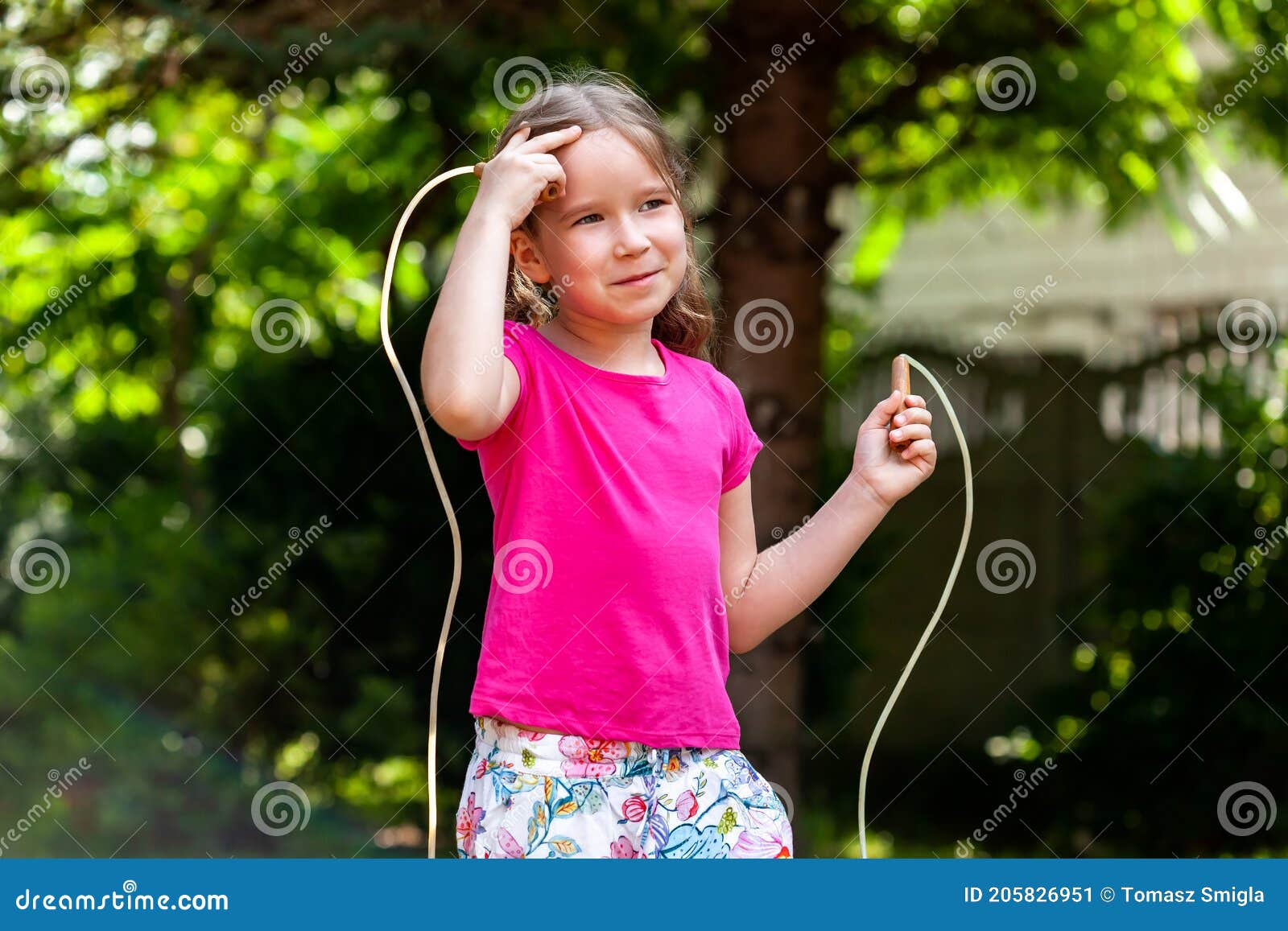 One Happy Little Girl, Child with a Jumping Rope in the Garden