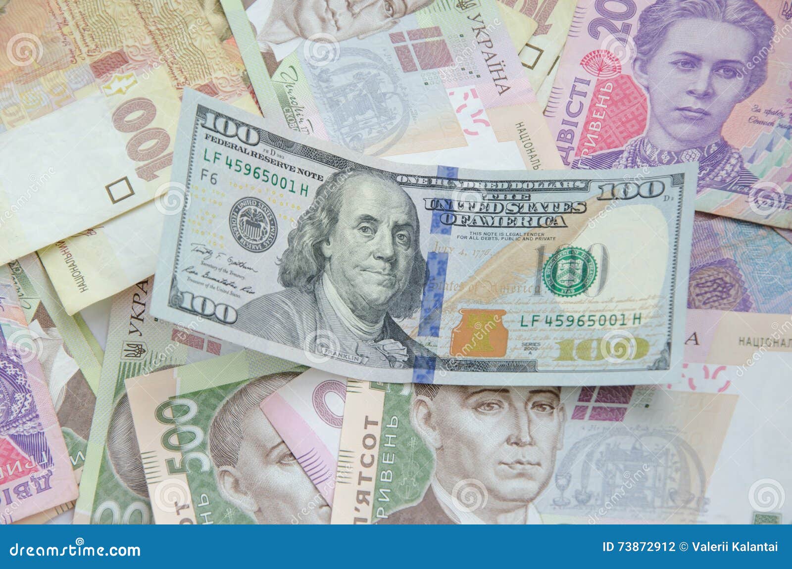 One Hundred Dollar Bill On The Background Of Ukrainian Hryvnia Stock one-hundred-dollar-bill-on-the-background-of-ukrainian-hryvnia-stock