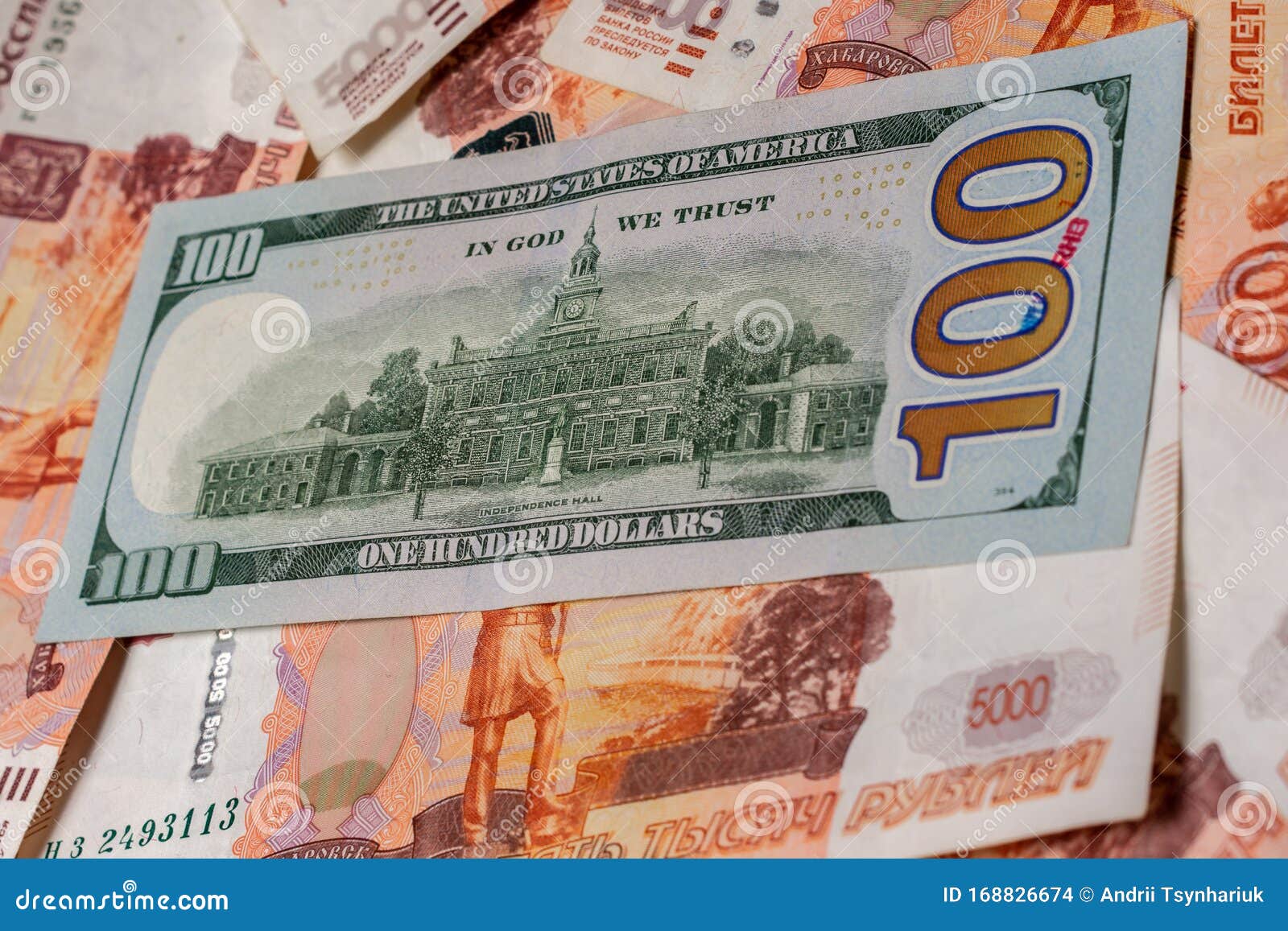 One Hundred Dollar Bill Lies On 5000 Russian Rubles The Side Where The one-hundred-dollar-bill-lies-on-5000-russian-rubles-the-side-where-the