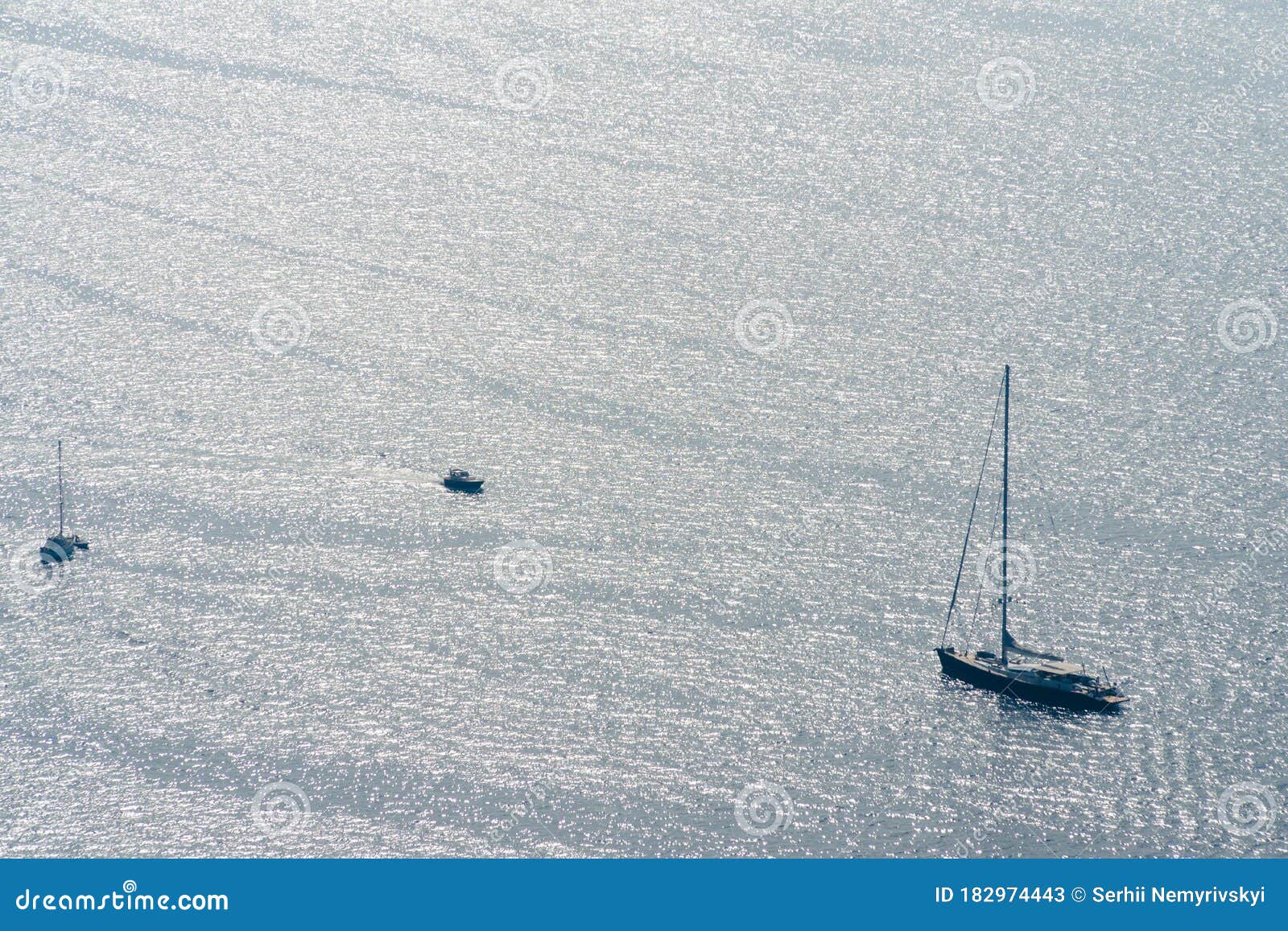 one-masted sailing yacht. luxury hobbi on the sea at distance on right side of the frame.. copy space. day time. travel and