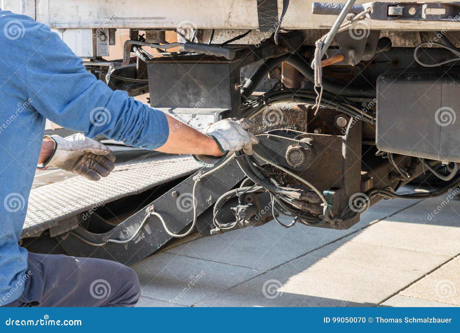 One Mechanic is Operating a Loading Ramp of a Truck Stock Photo Image