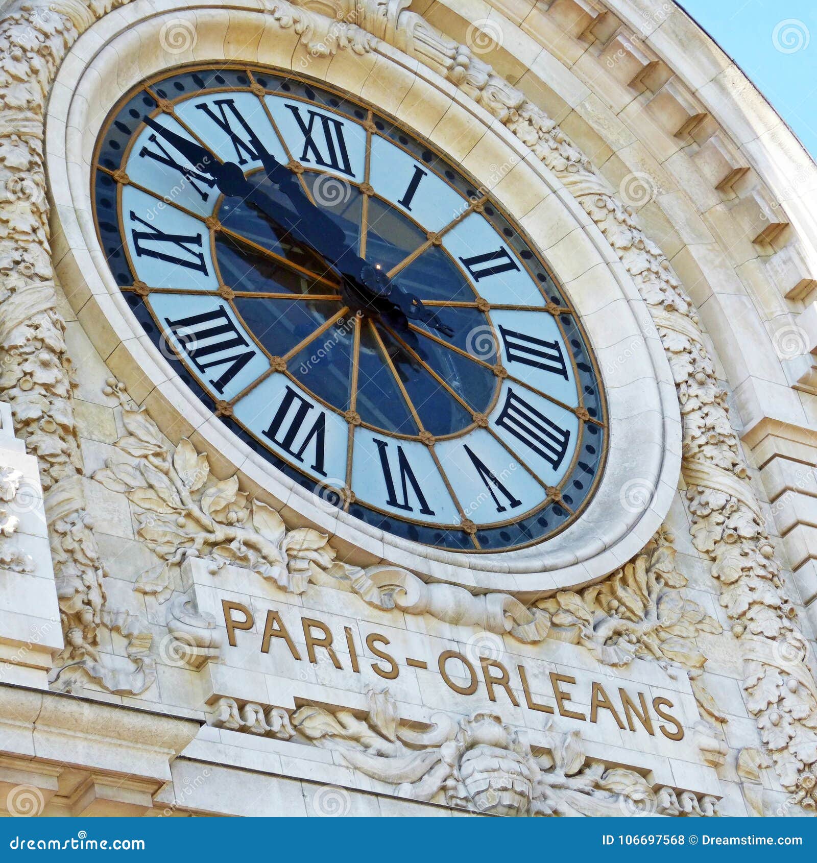 clock at the front of a building in paris