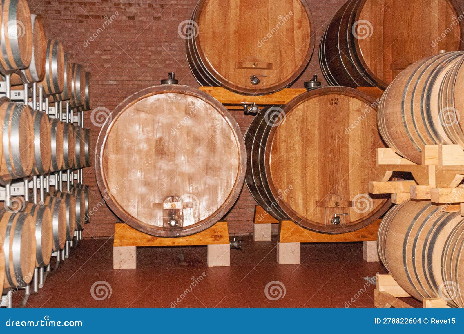 one old and failed oak barrel with new wood barrels, in winery cellar