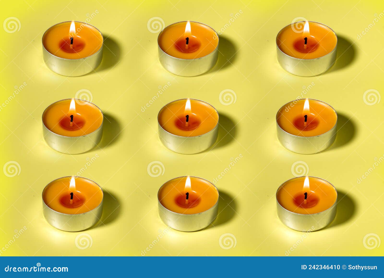 One Orange Lit Aroma Candle on Yellow Background Flat Lay Stock Photo