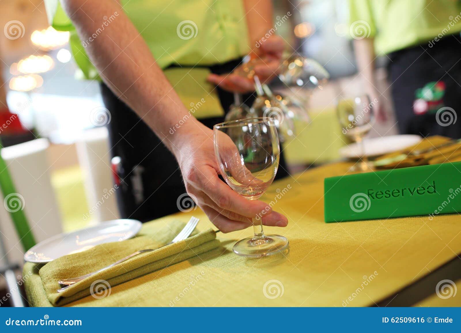 One of Waiters is Serving Dinner Place in a Restaurant Stock Photo