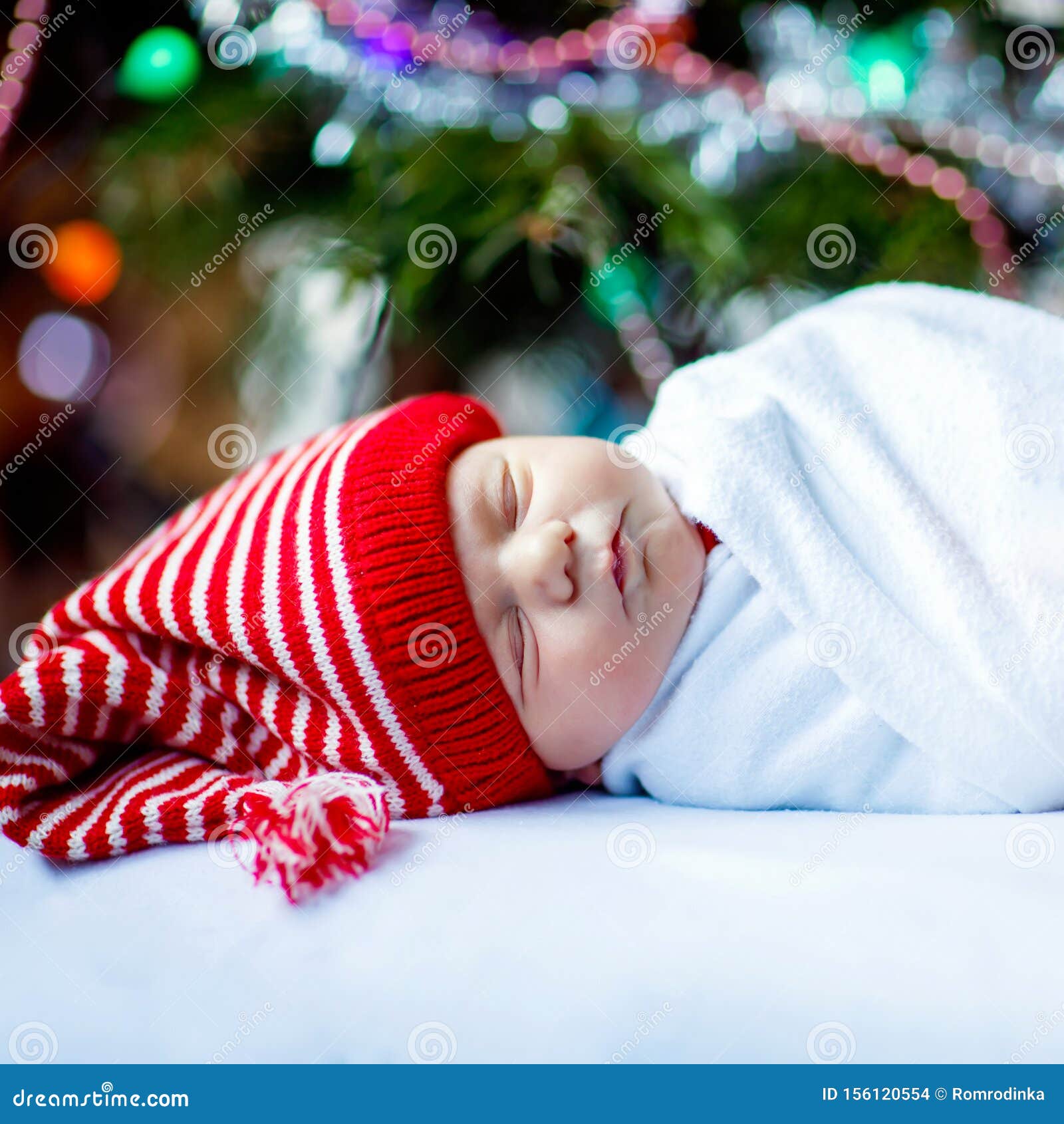 One Week Old Newborn Baby in Santa Hat Wrapped in Blanket Near ...