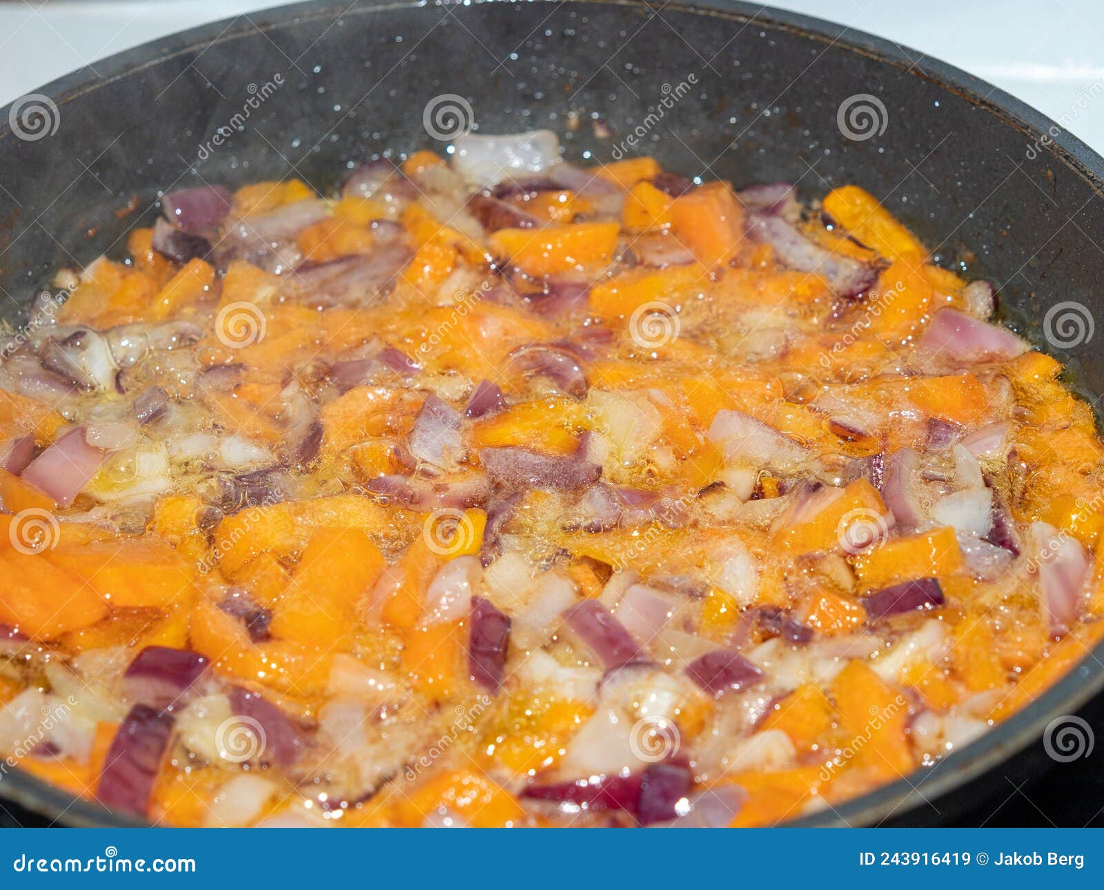 Onions and Carrots are Fried in a Pan. Stock Image Image of