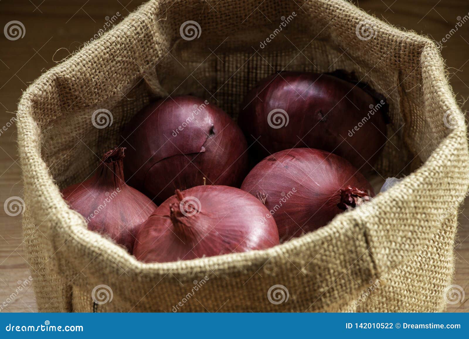 Premium Photo  Fresh red onions in bag on wooden