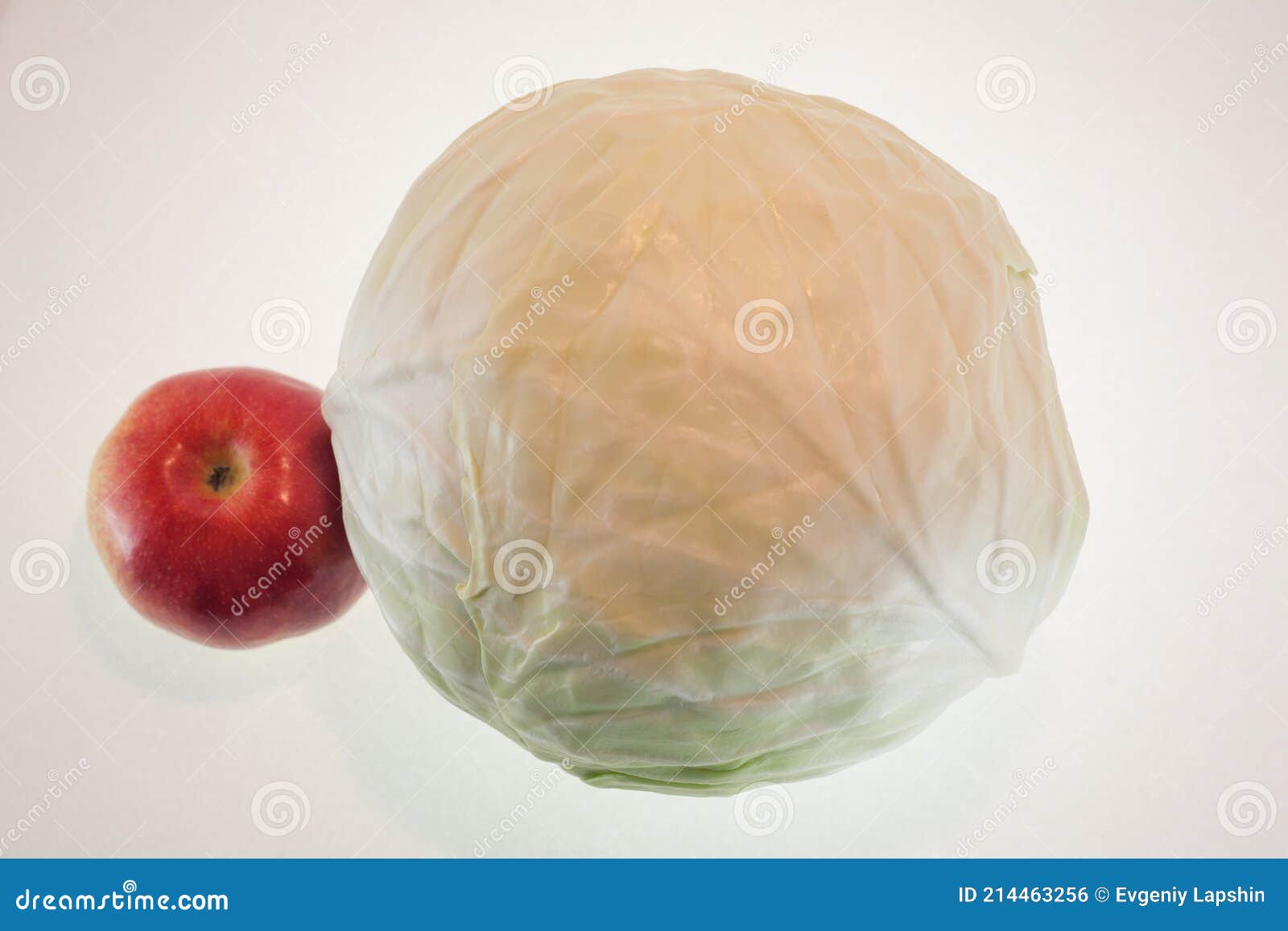 onions in a paper bag and an apple, white background, fruit and freshness, aphorisms written on paper