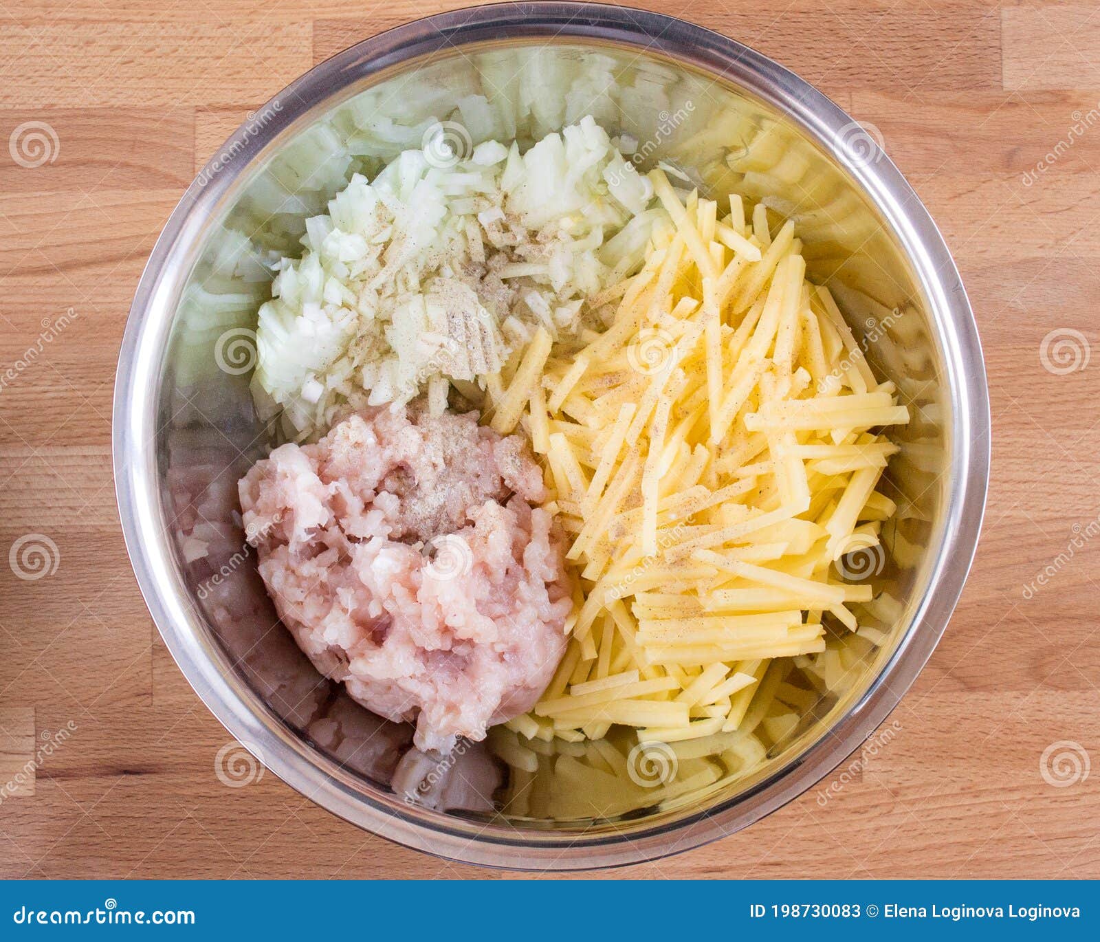 onions, potatoes and minced meat in a bowl. top view, ingredients for the pie