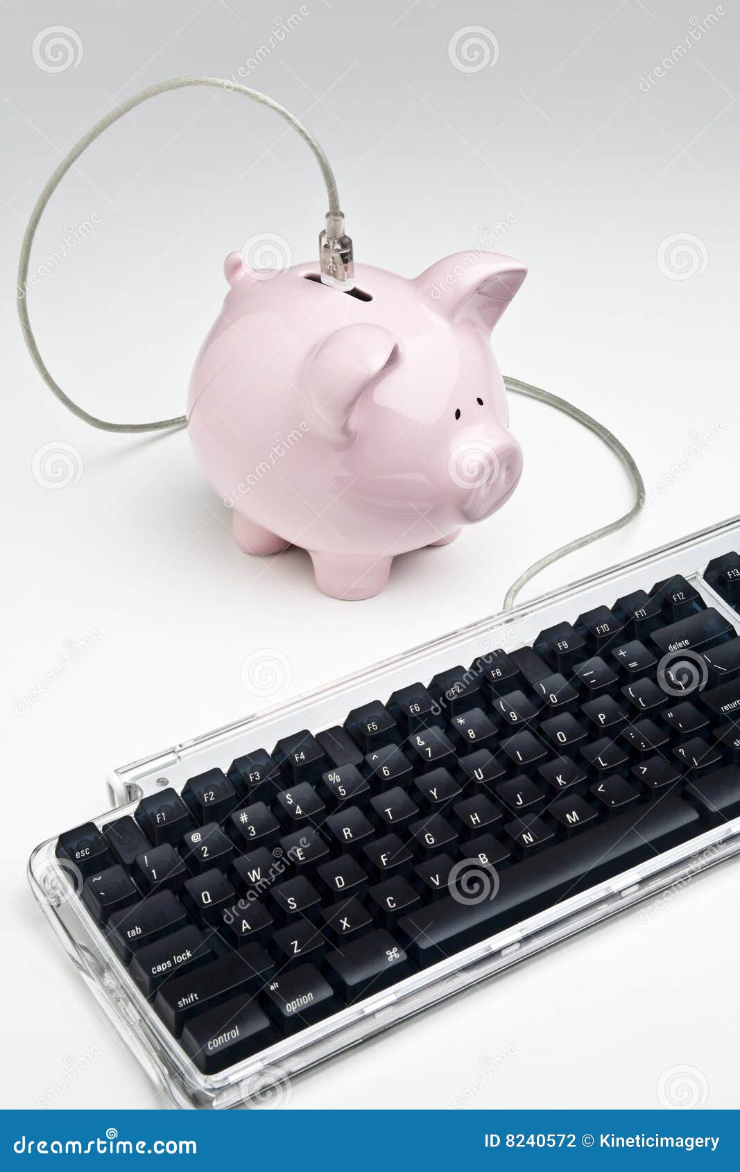 Online banking. Computer keyboard connected to a piggy bank