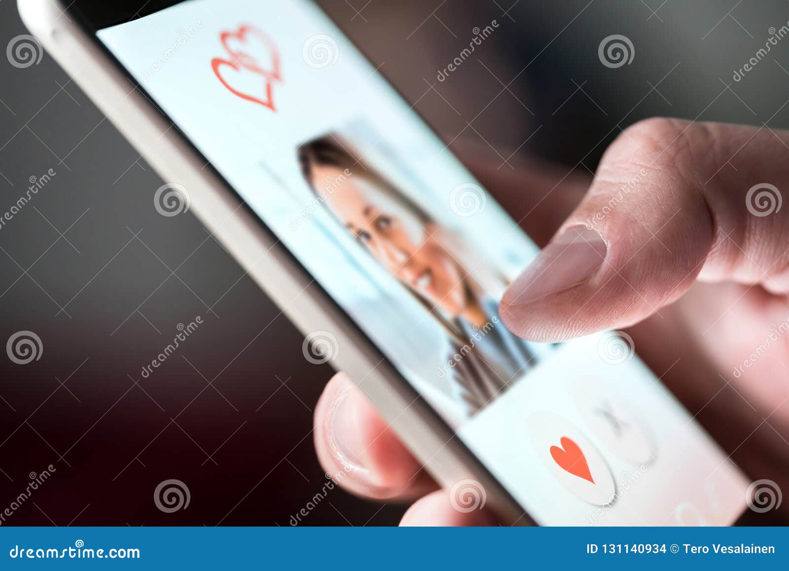online dating app in smartphone. man looking at photo of beautiful woman.