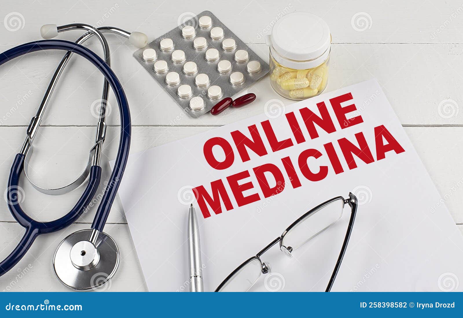 online medicina word on paper with stethoscope and pills