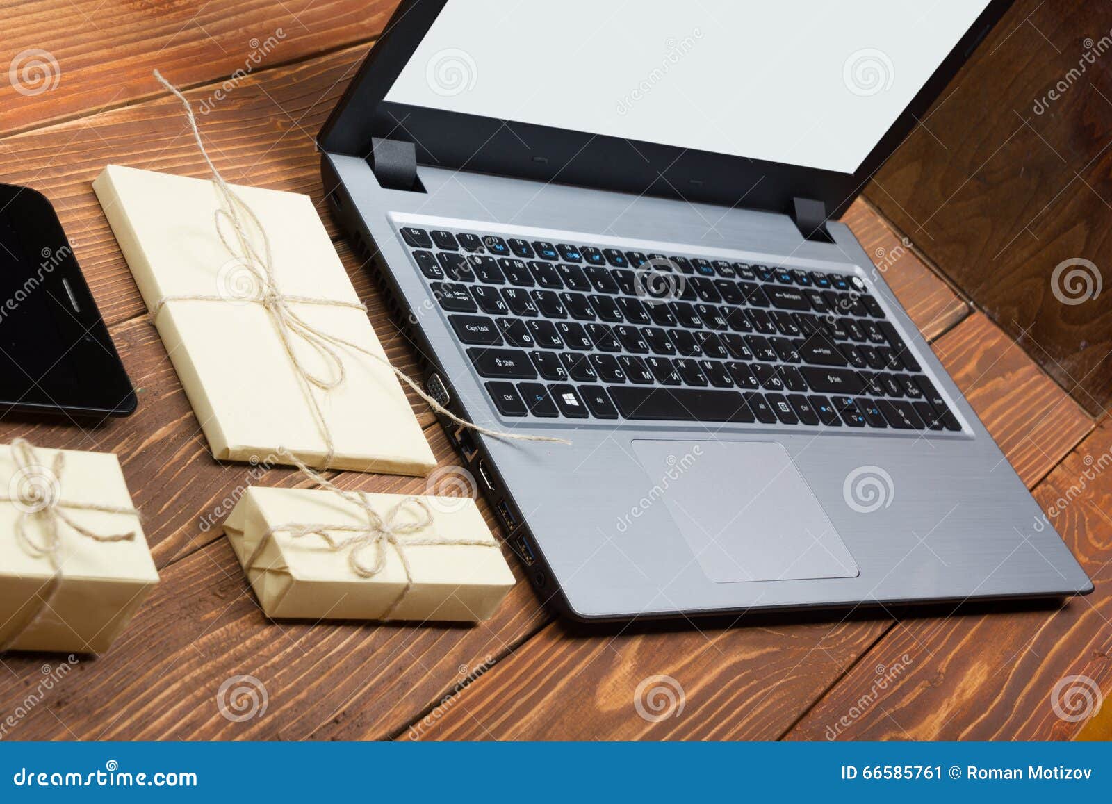 Online shopping concept - Empty Shopping Cart, laptop and tablet pc, gift box on rustic wooden backgroun.