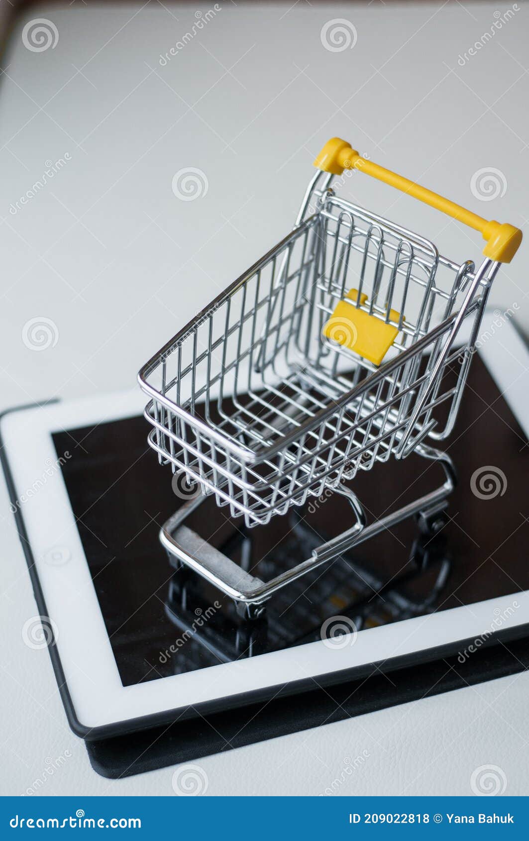 online shopping concept. shopping cart  small boxes  laptop on the desk