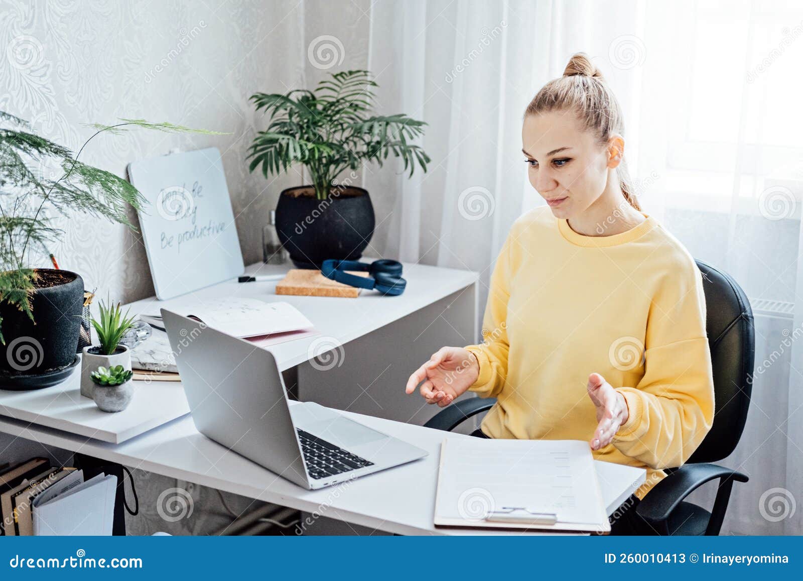 online side hustle ideas to make money fast. young woman speaking in front of laptop as consultant, blogger, recording