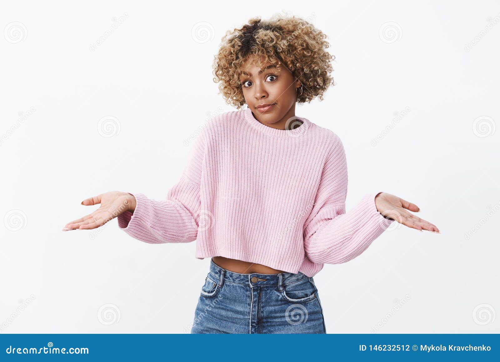 oops did not know. cute silly african-american girlfriend with blond haircut making innocent and unaware look shrugging